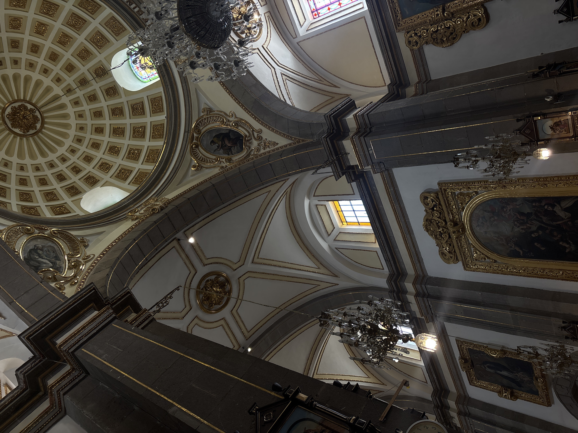 Visitor documents ornate church interiors in historic Puebla, Mexico