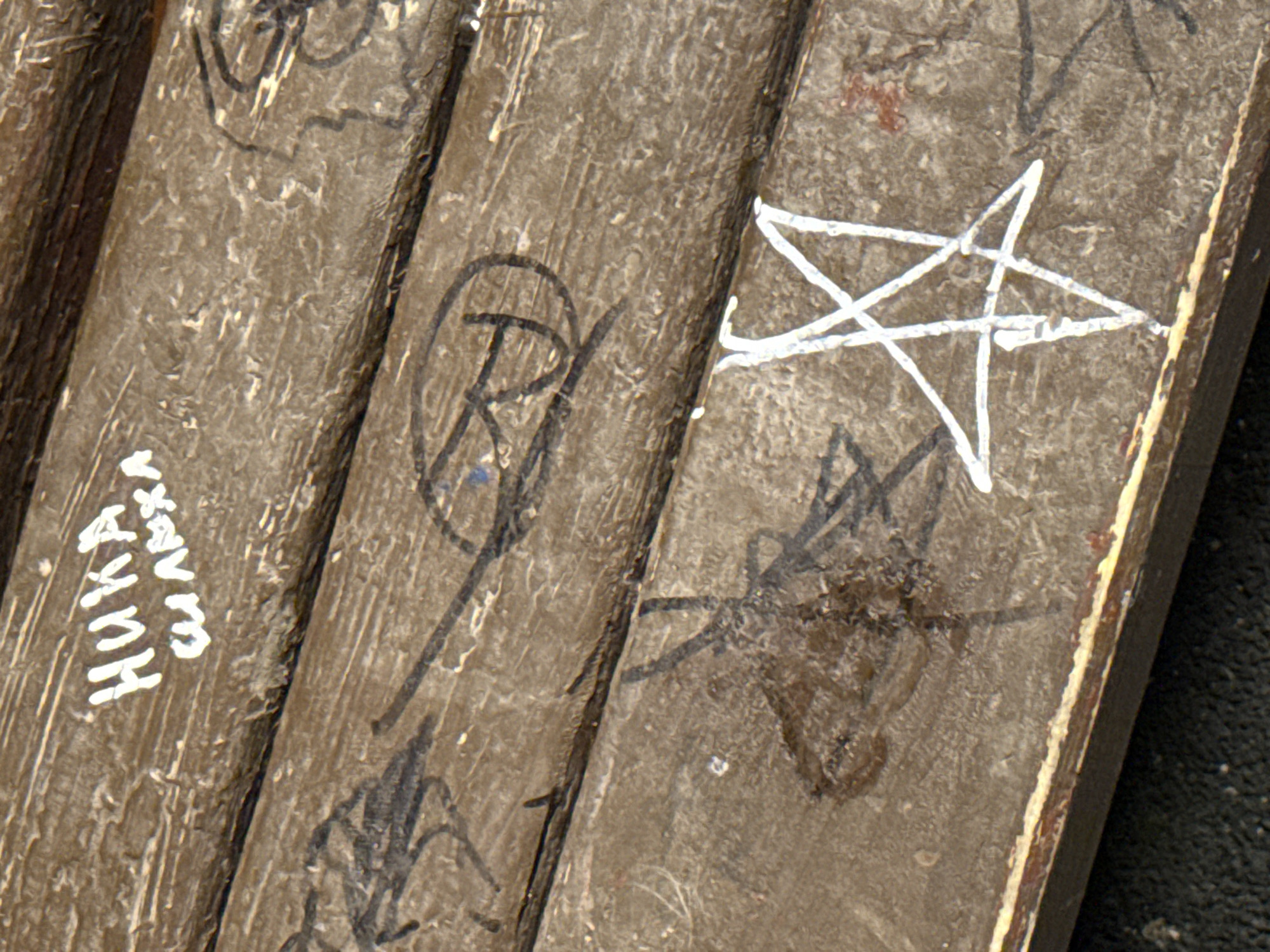 Graffiti-marked wooden planks with Cyrillic script
