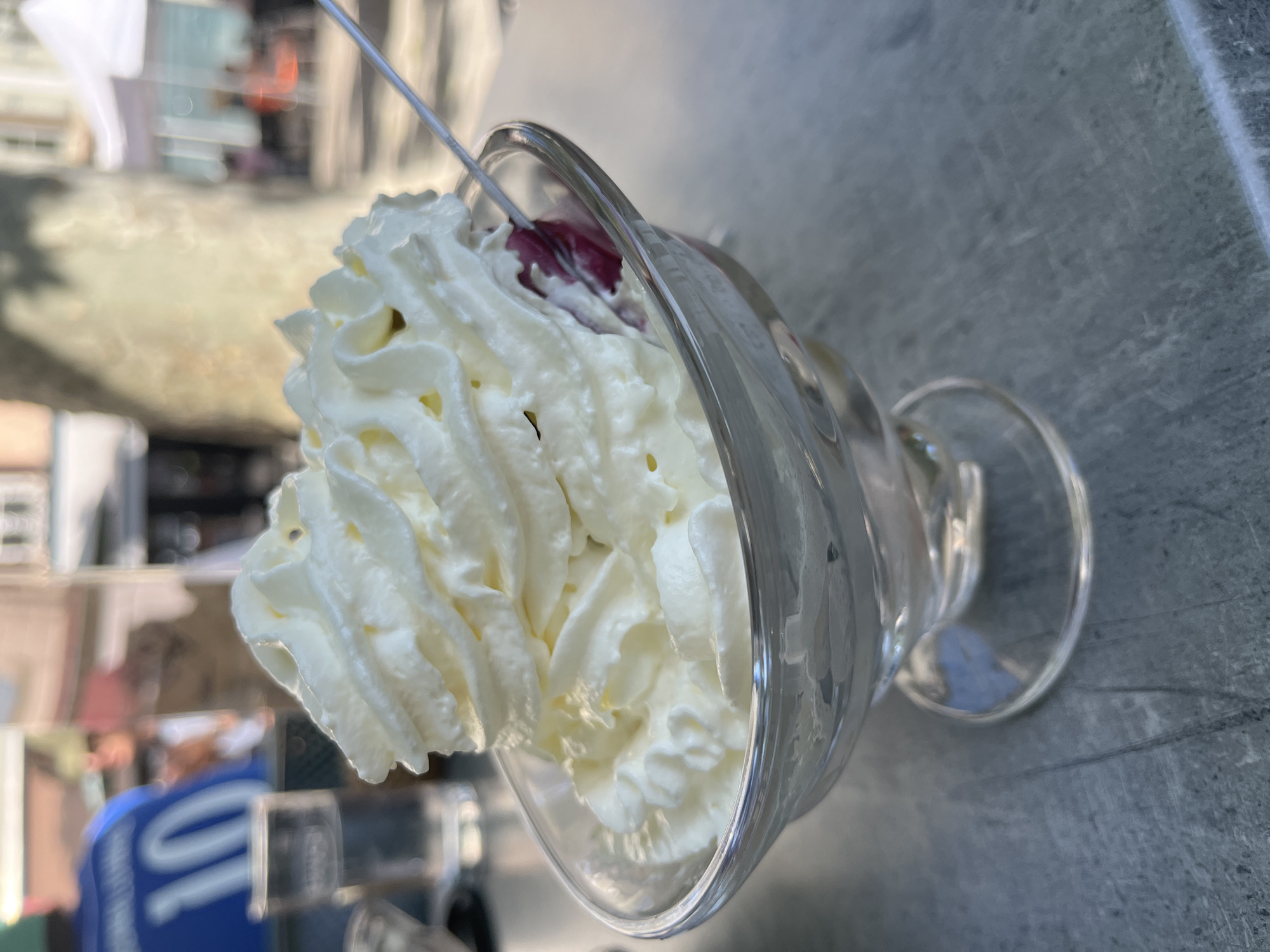 Woman enjoys dessert at outdoor cafe in Montbrison