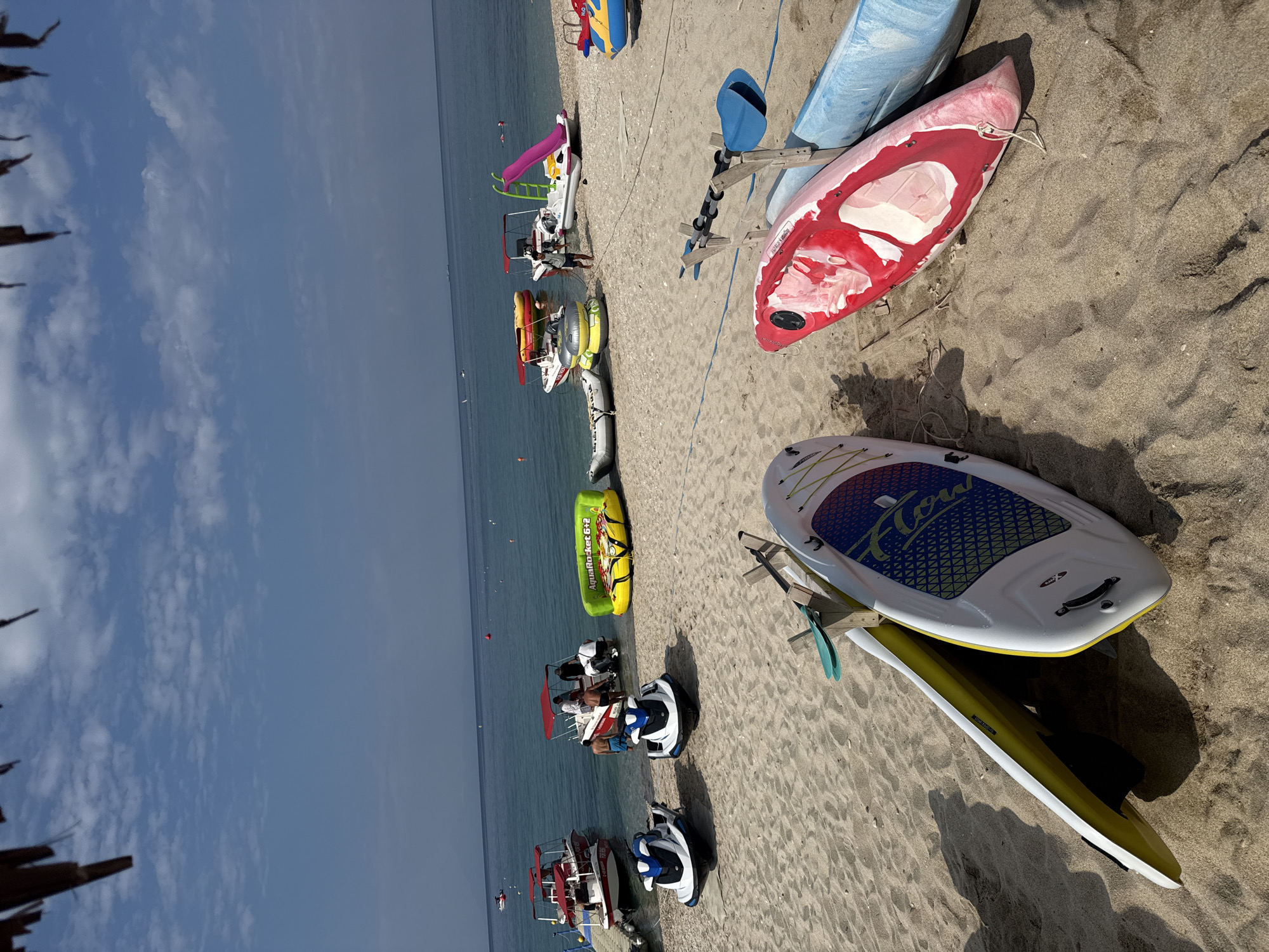 Jet skis on sand and beachwear for sale in Potos, Greece
