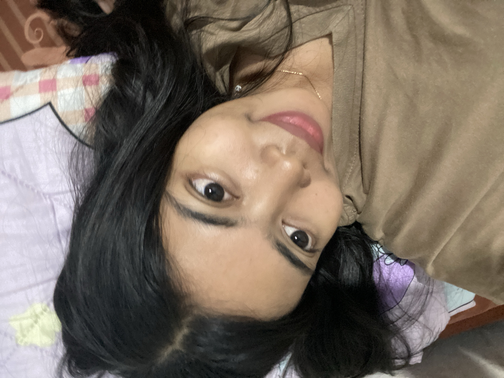 Relaxed bedroom selfie moment in Madiun, Indonesia