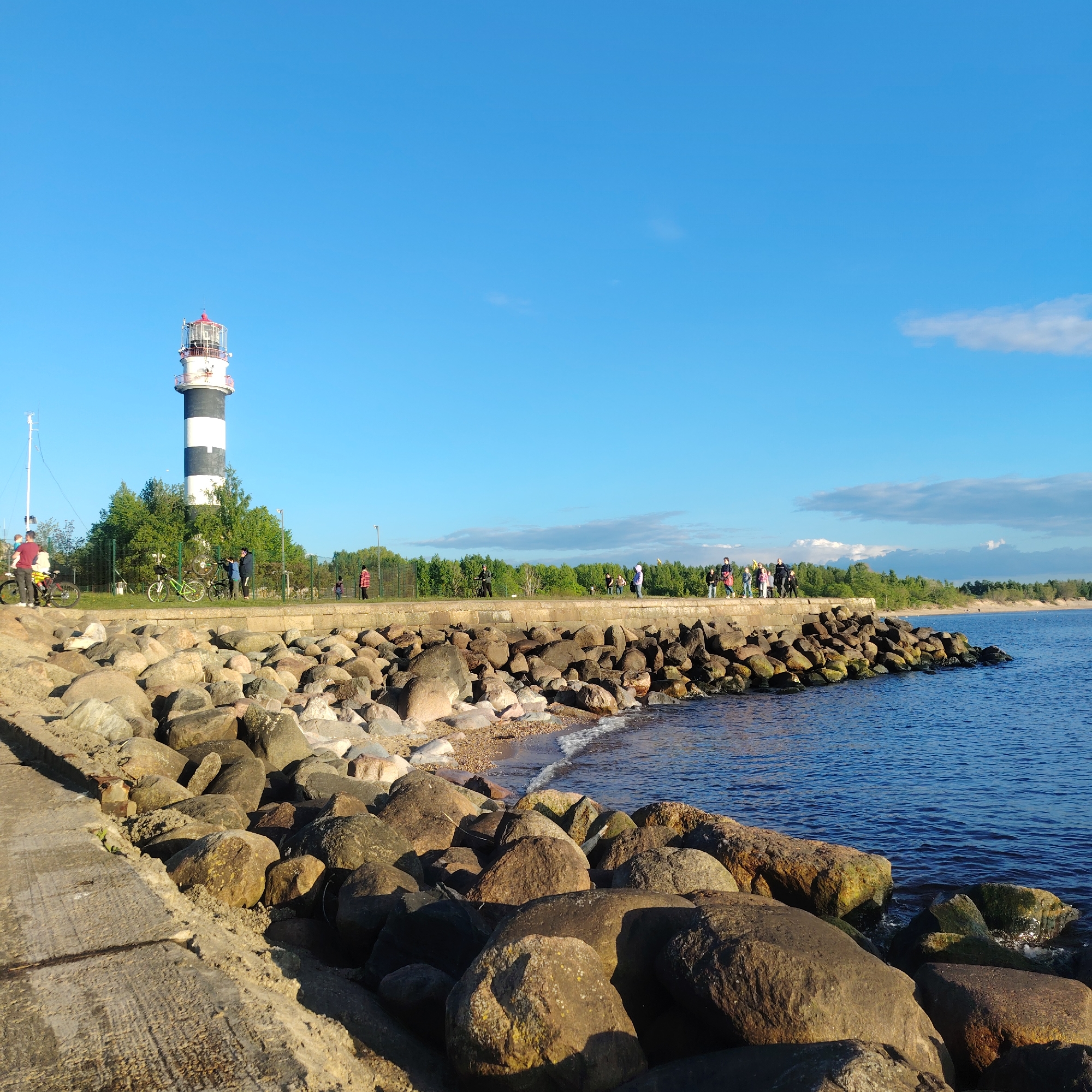 Evening coastal life documented around Riga's port and lighthouse