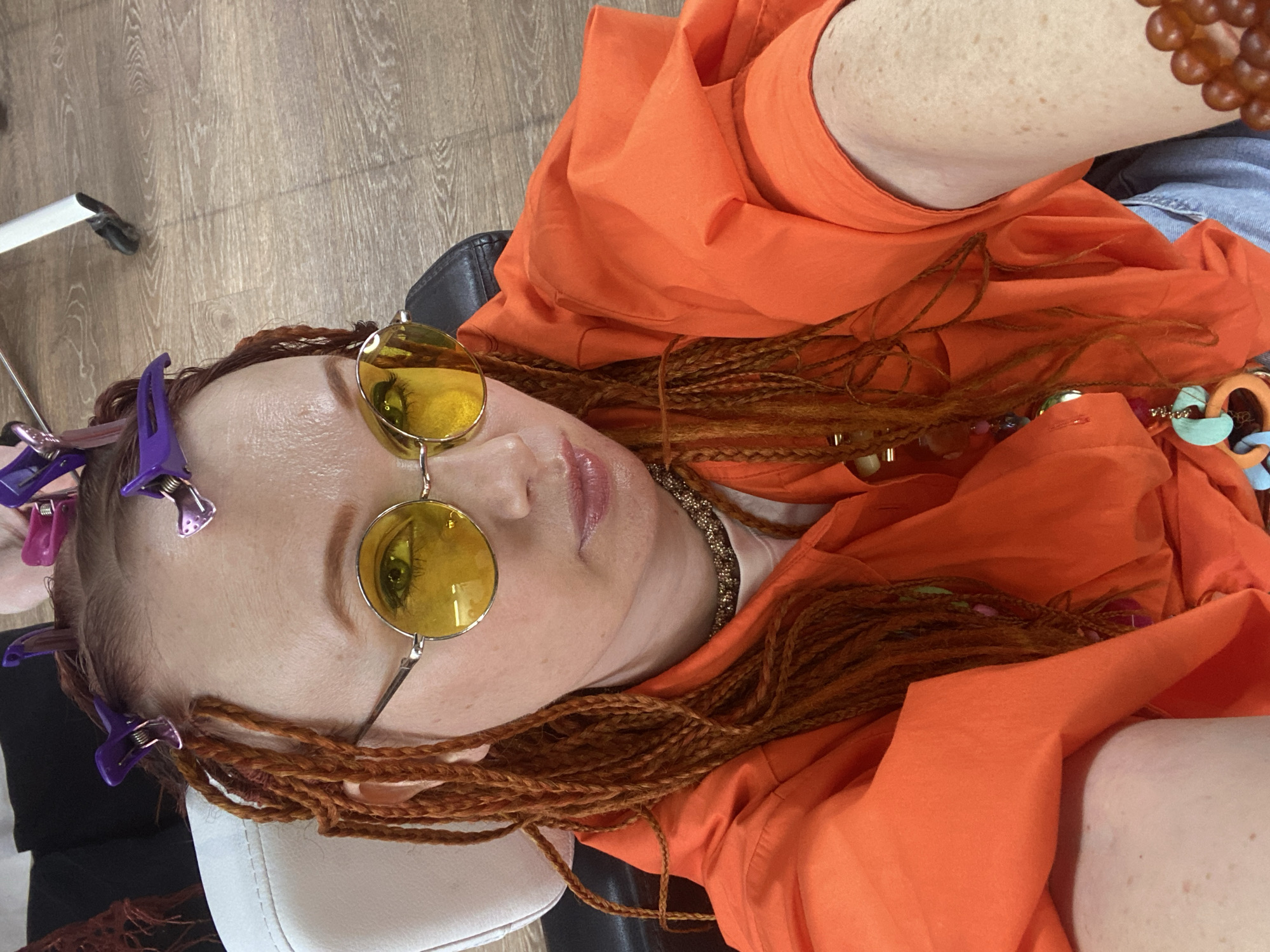 Woman documents dreadlock styling session at Sochi hair salon