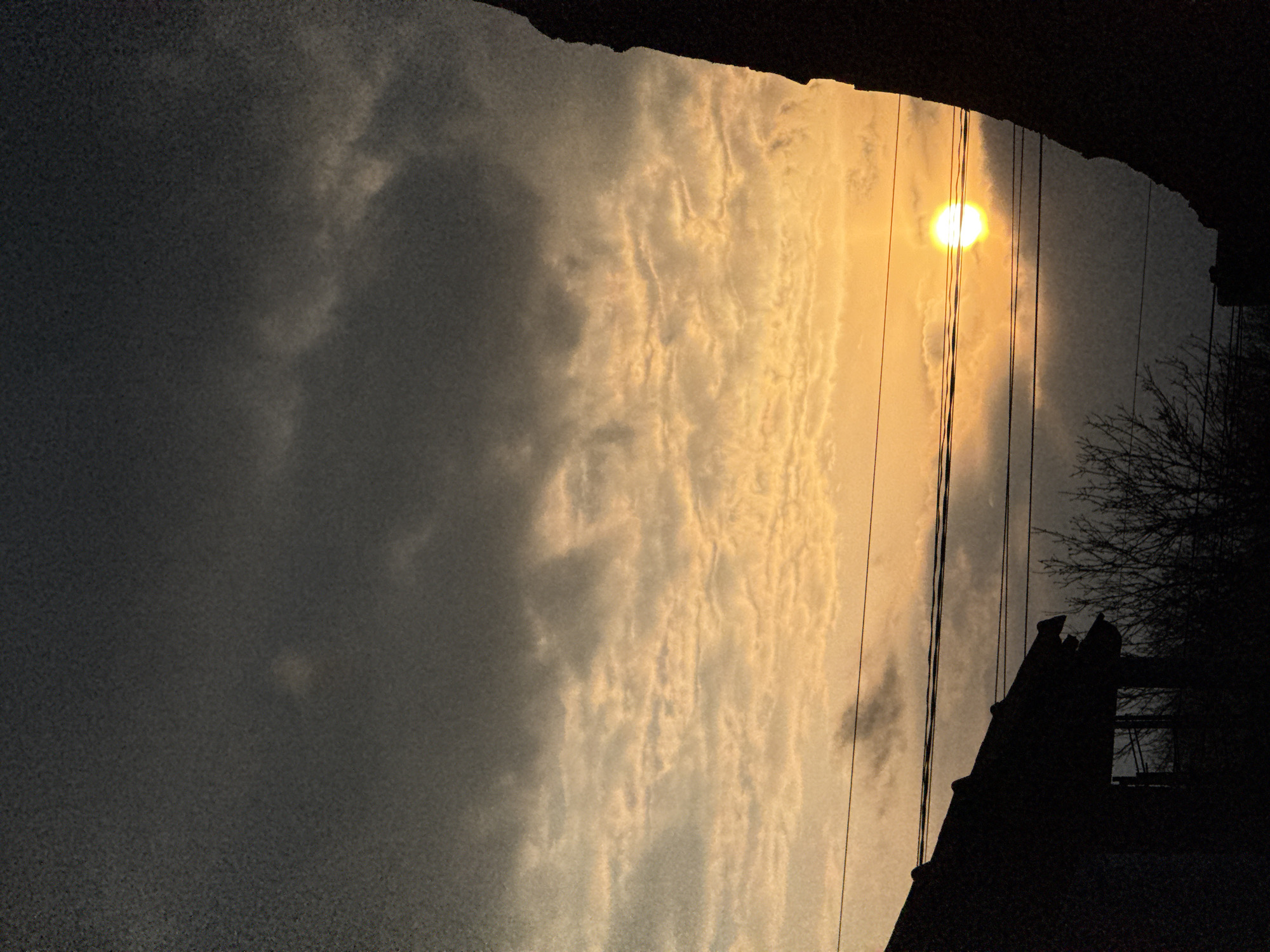 Twilight scene captured in Dobrich, Bulgaria with sun behind clouds