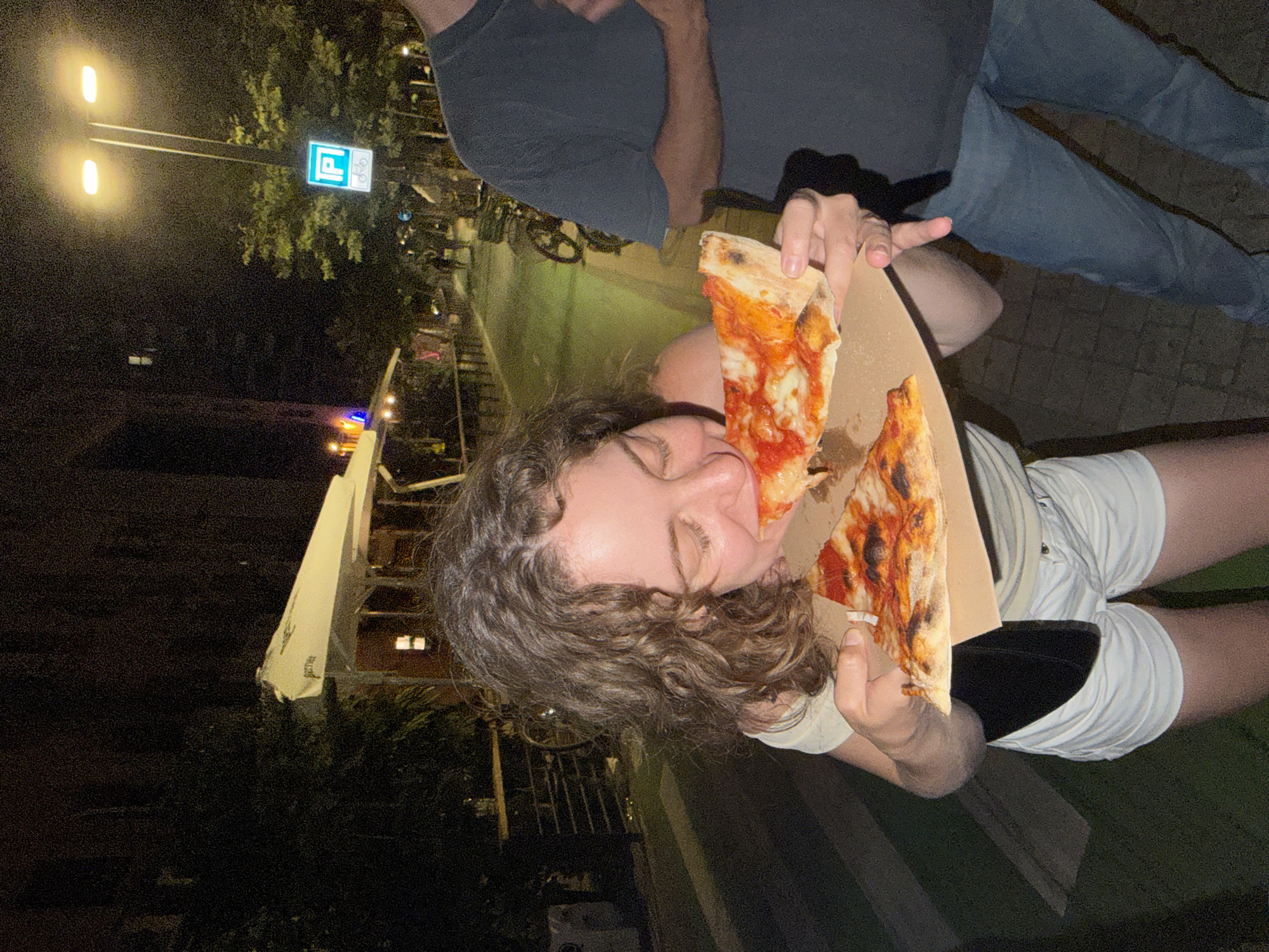 Late-night Tel Aviv street scene: food, wine, and a Yorkie