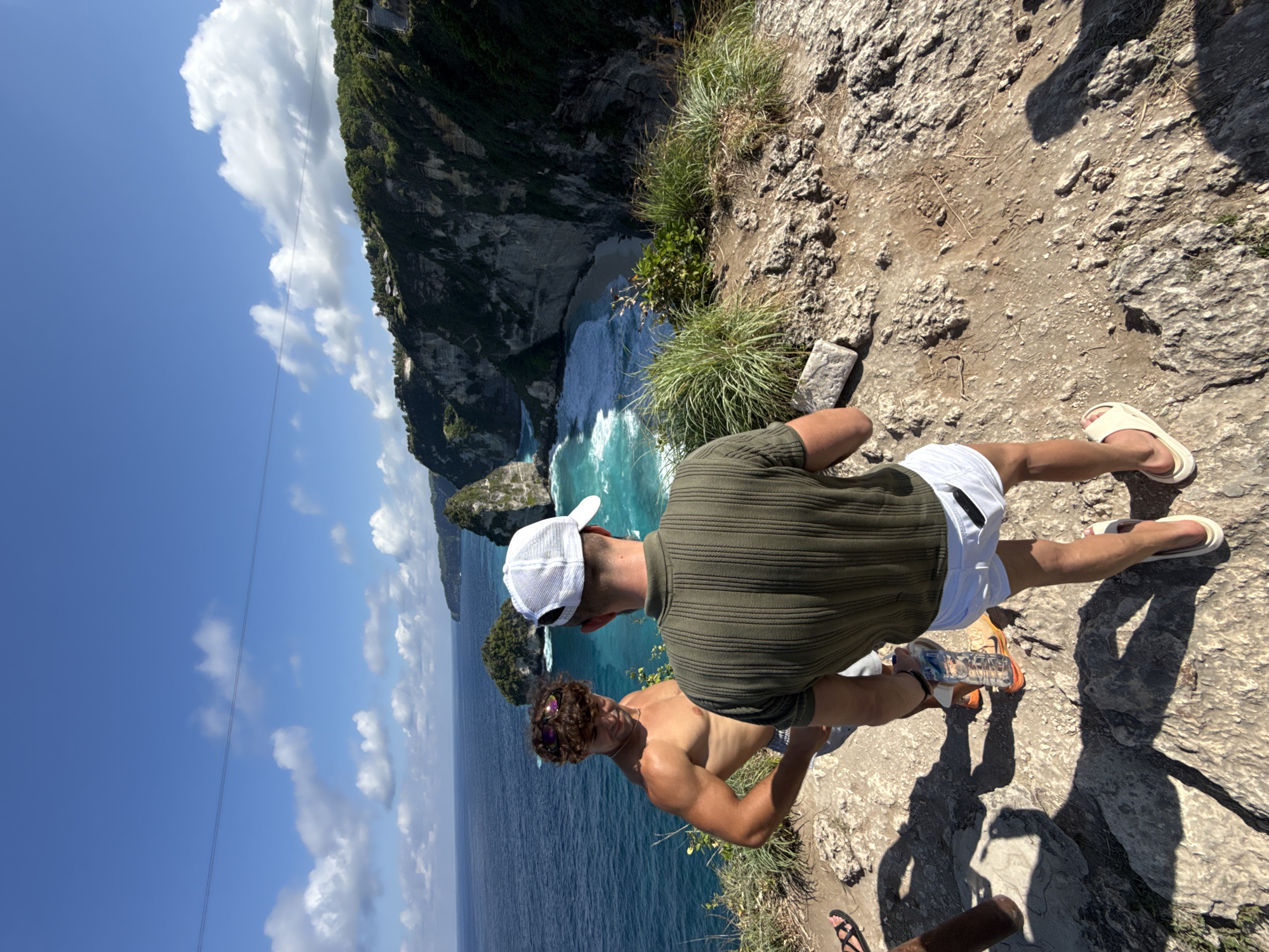 Two men stand on cliff edge in Nusa Penida