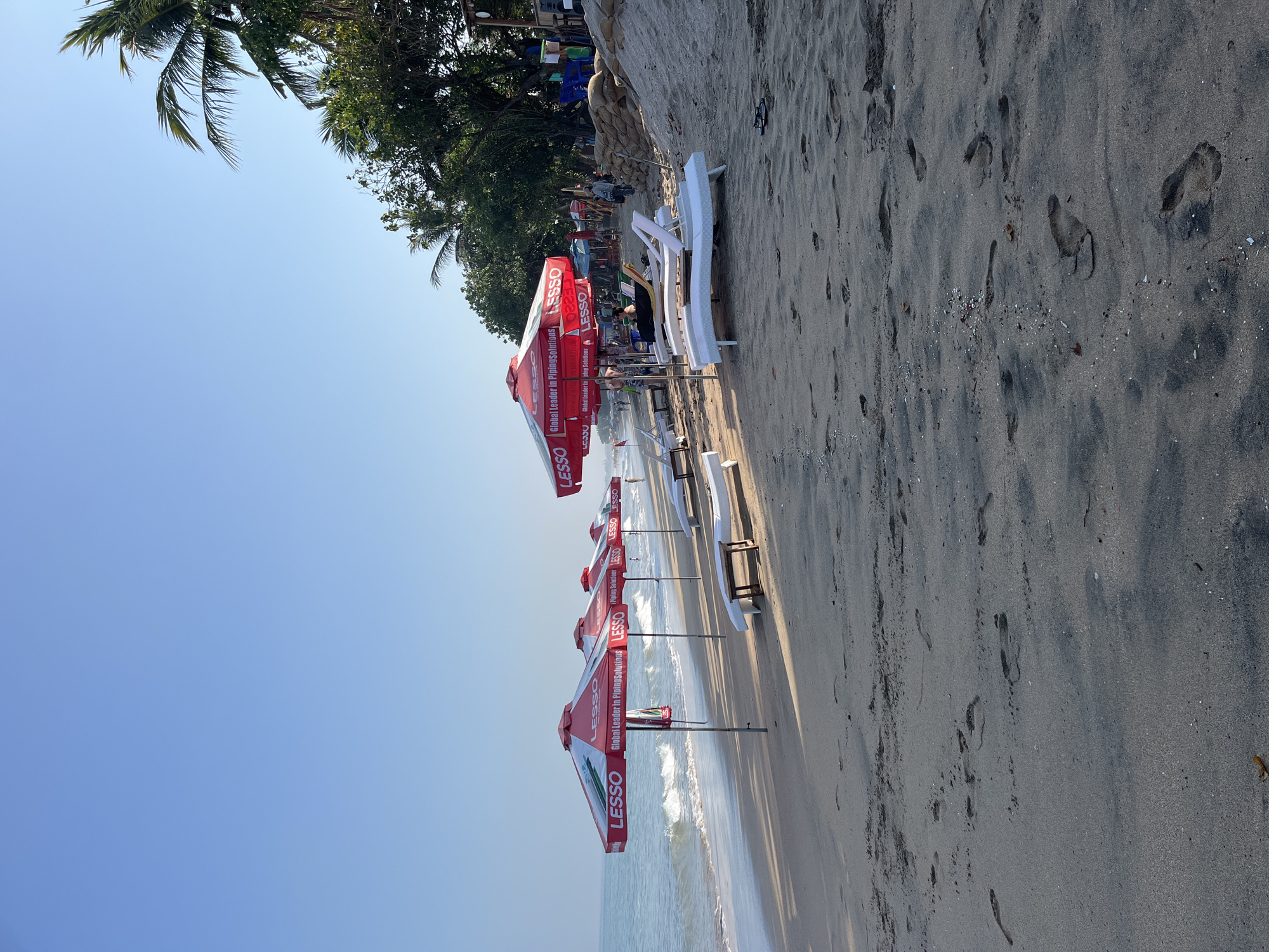 A regular afternoon at Kuta Beach, surfers and sun.