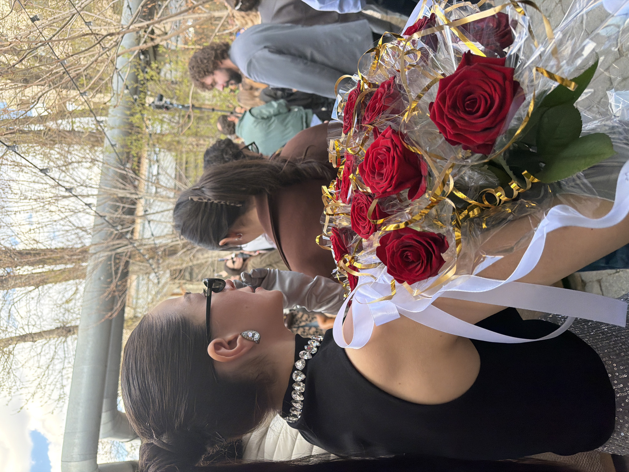 Woman with diamond jewelry holds rose bouquet in Moscow