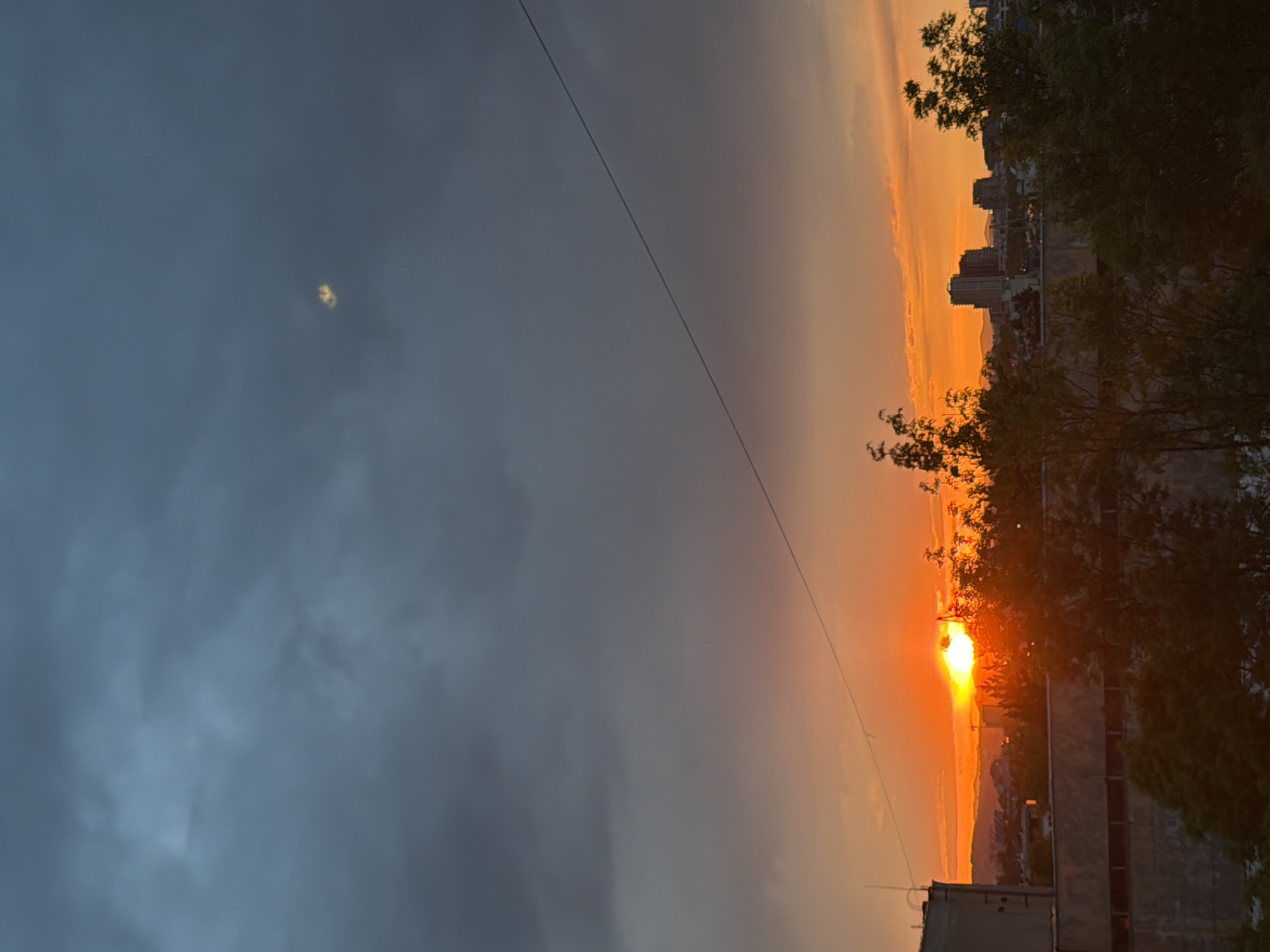 Contrasting sunset divides Sofia sky into dark and orange halves