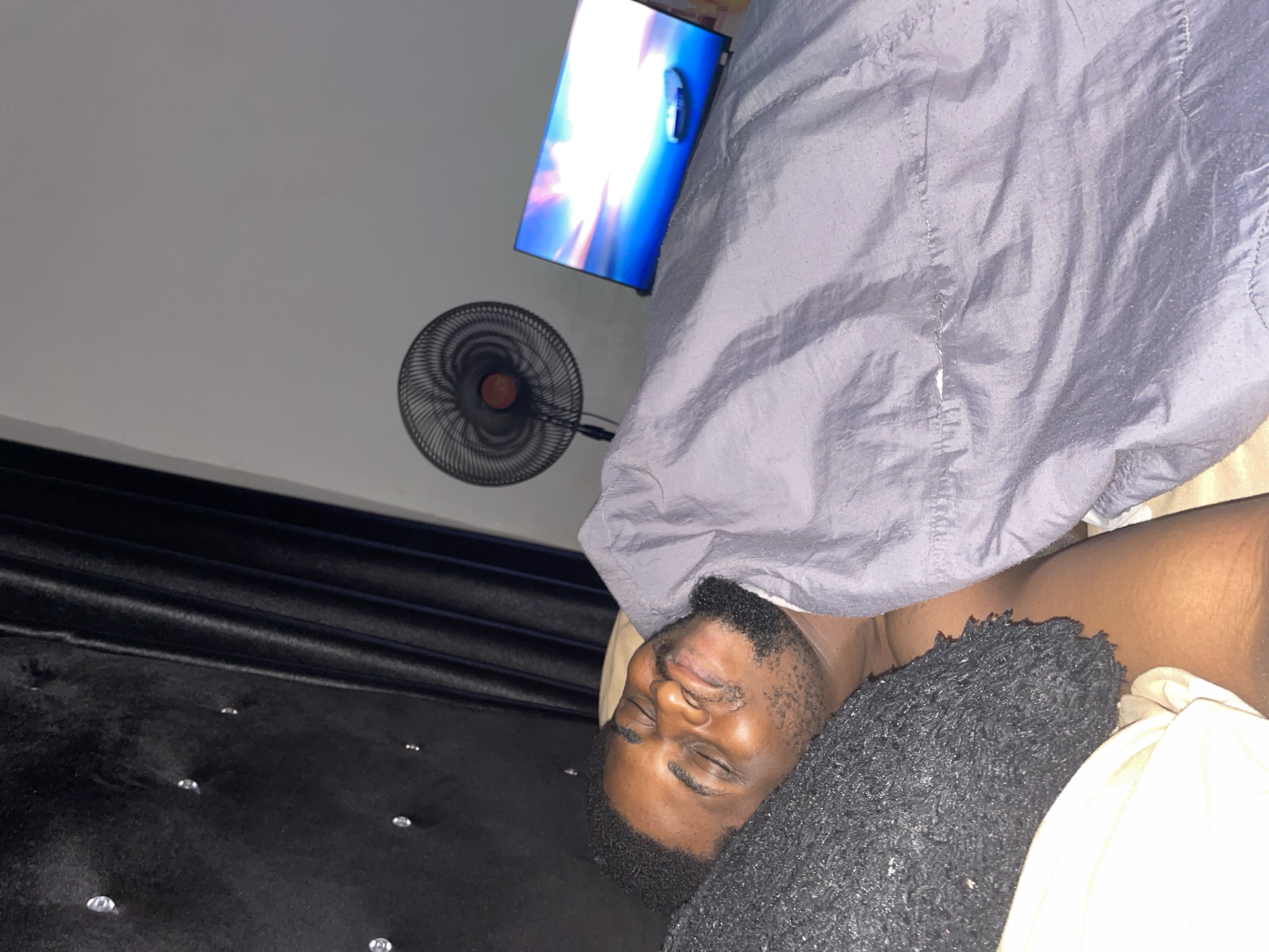 Man resting in bedroom in Akwanga, Nigeria