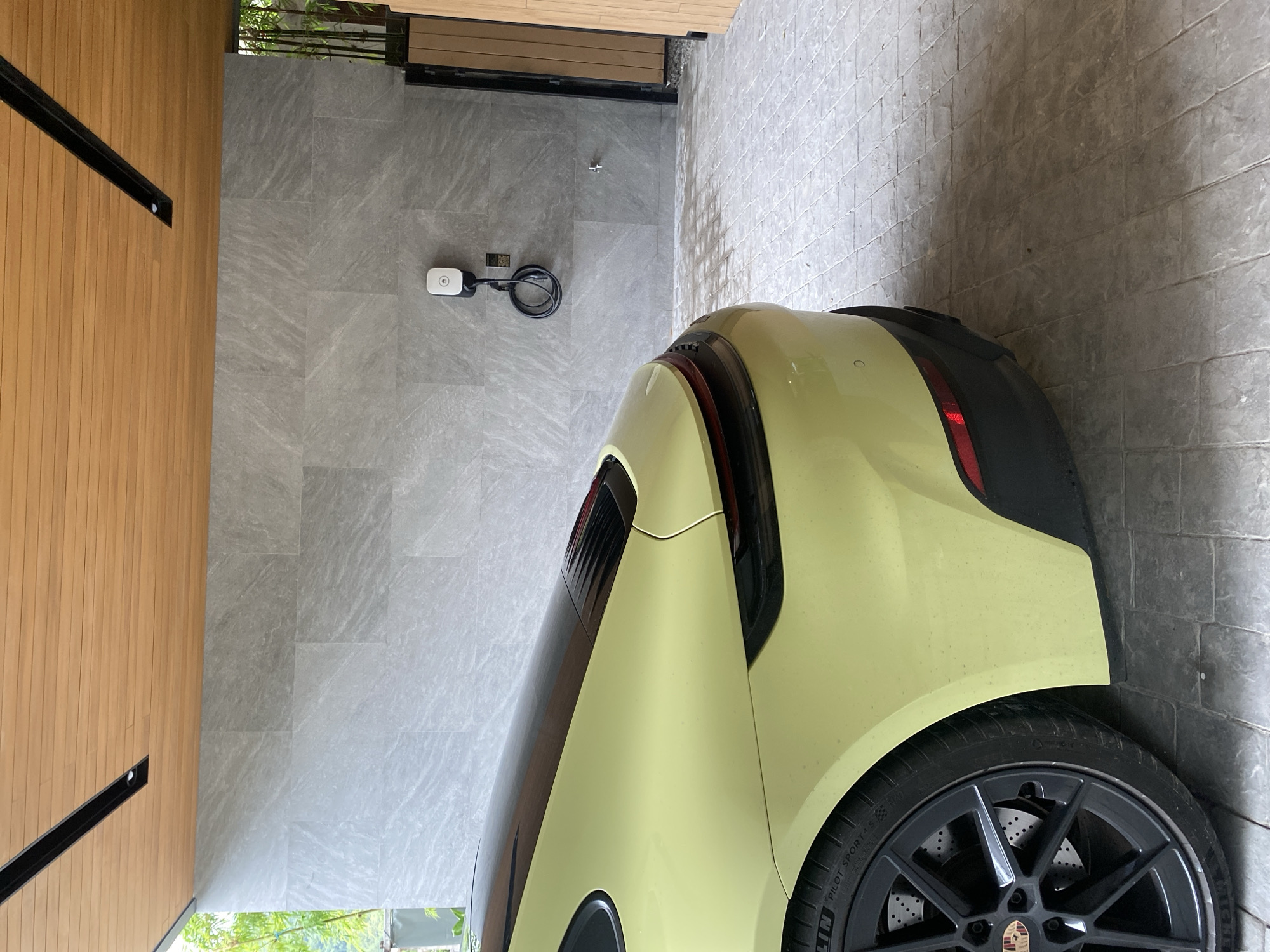 Yellow Porsche Taycan spotted charging at Choeng Thale residence