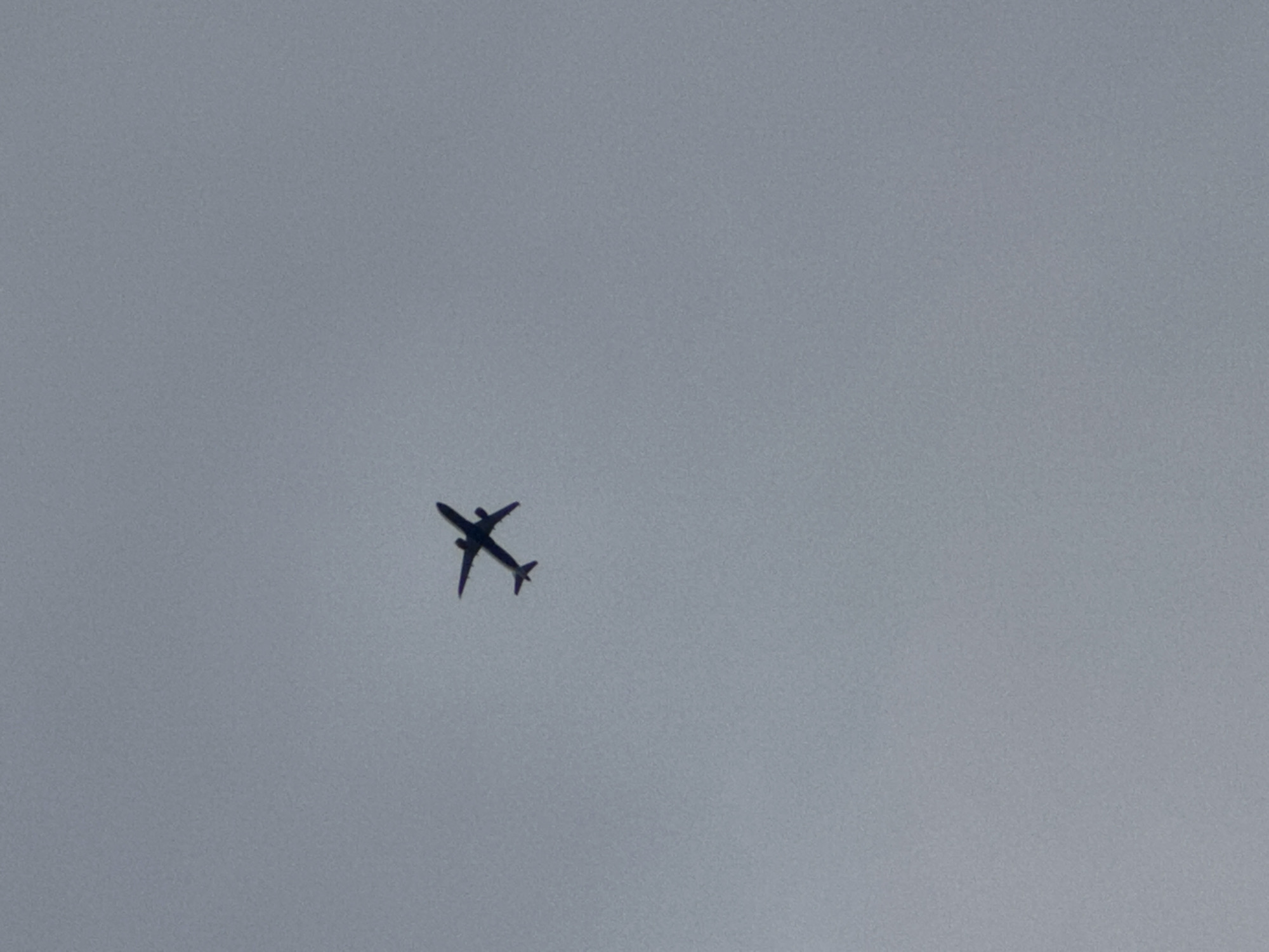 Commercial flight passing overhead, London skies, July evening