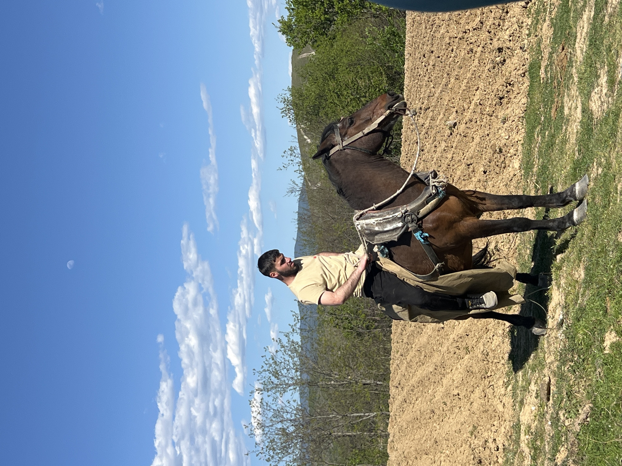 Man rides horse through Bulgarian countryside near Kornitsa