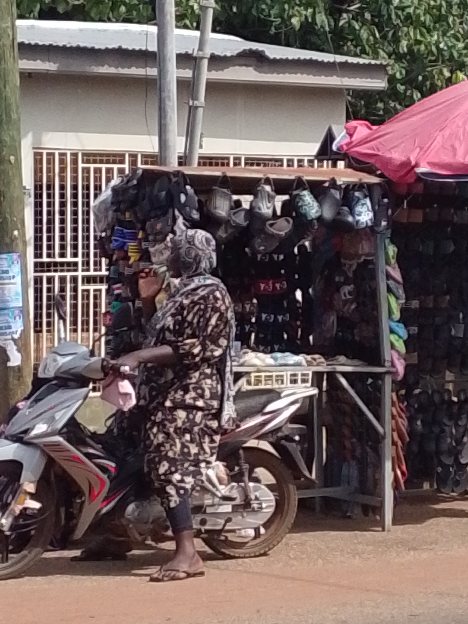 Daily street life continues around market vendors in Tamale