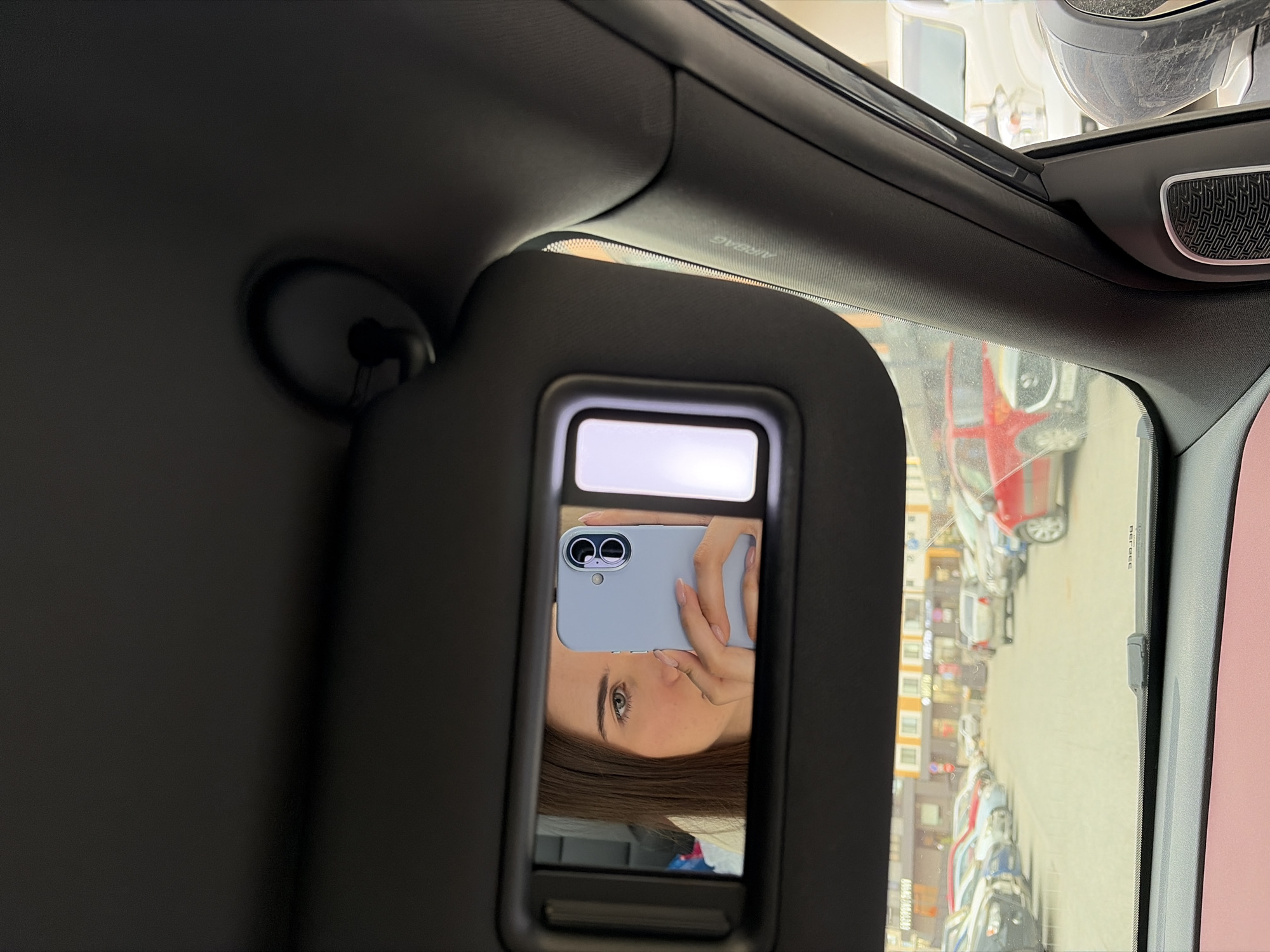 Woman takes playful mirror selfies in car in Izhevsk