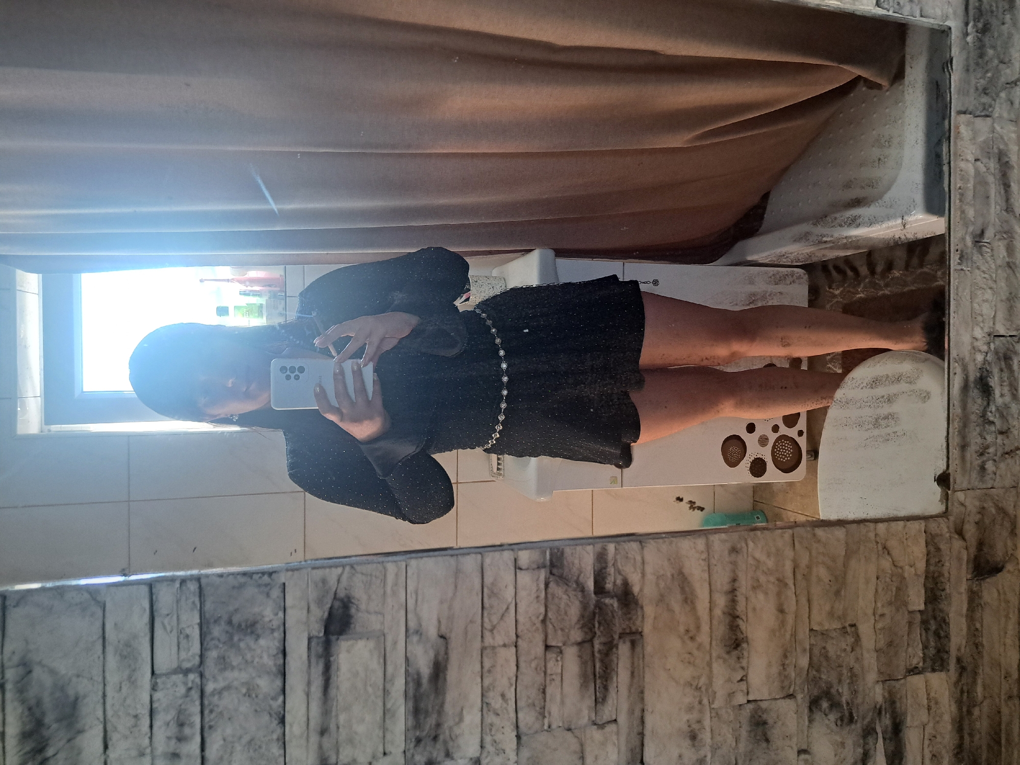Woman takes bathroom selfies in sparkly dress, Russia