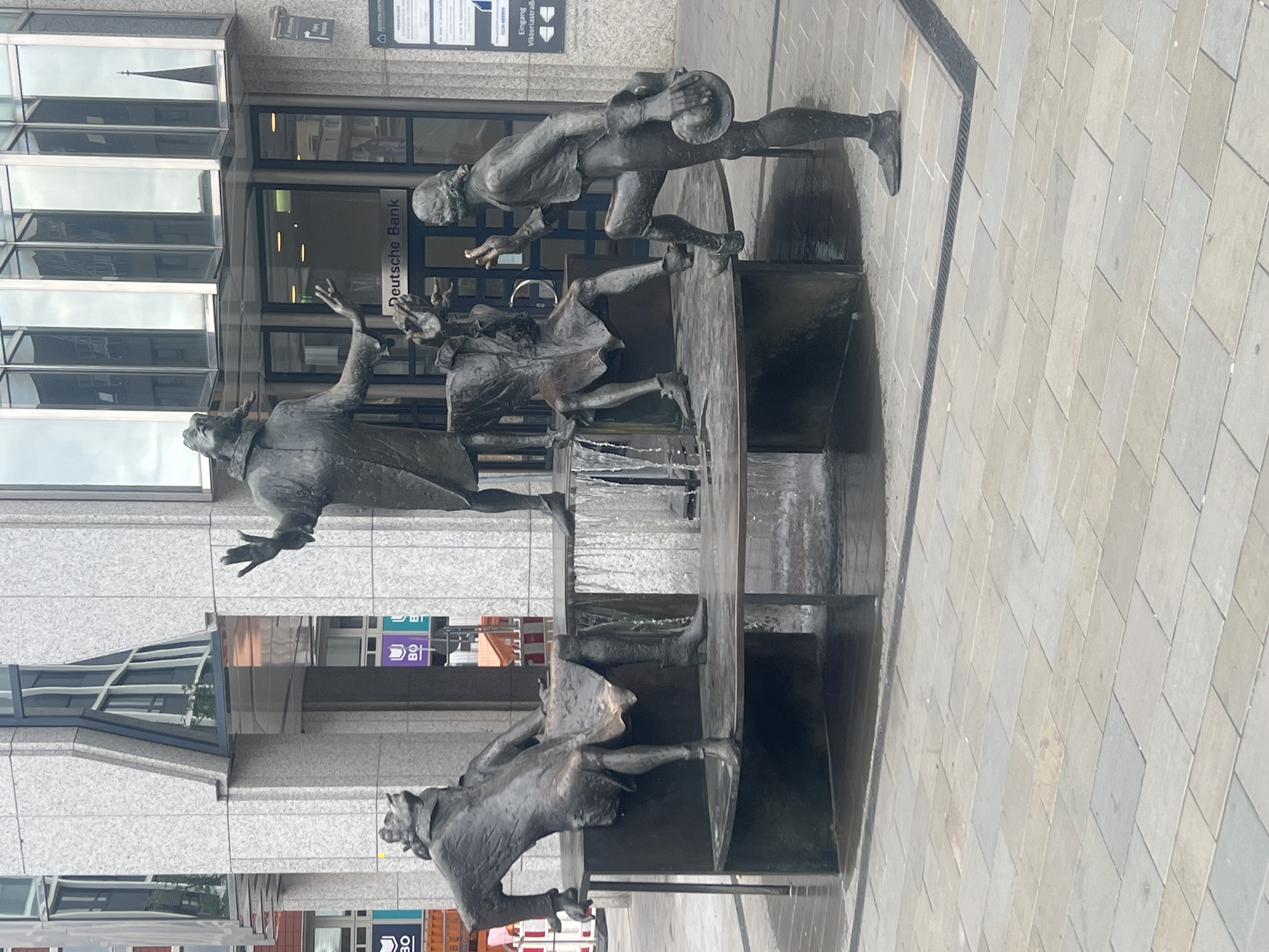 Bronze fountain sculpture with four figures in Bochum
