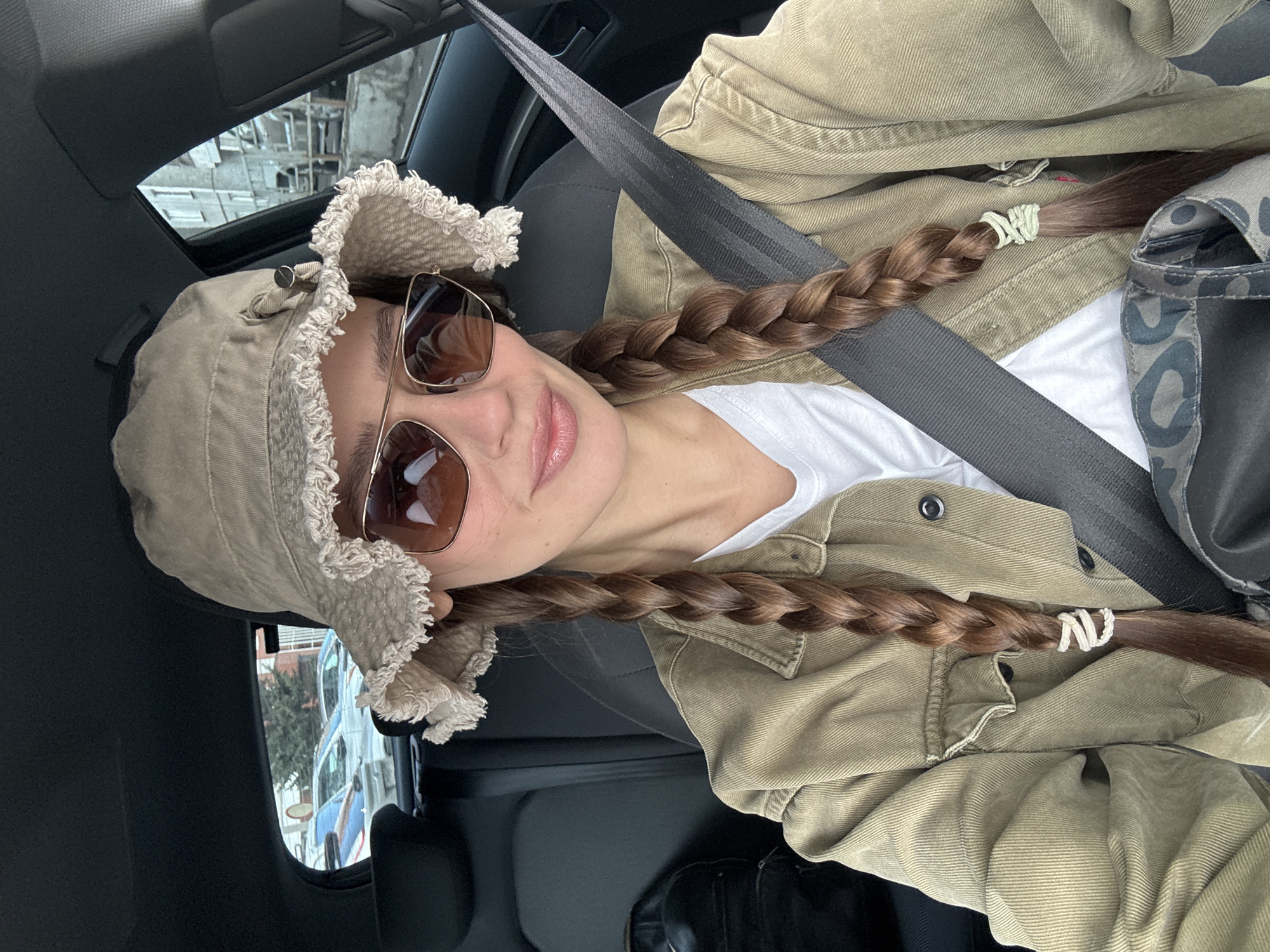 Woman takes car selfie in Krasnoyarsk wearing bucket hat