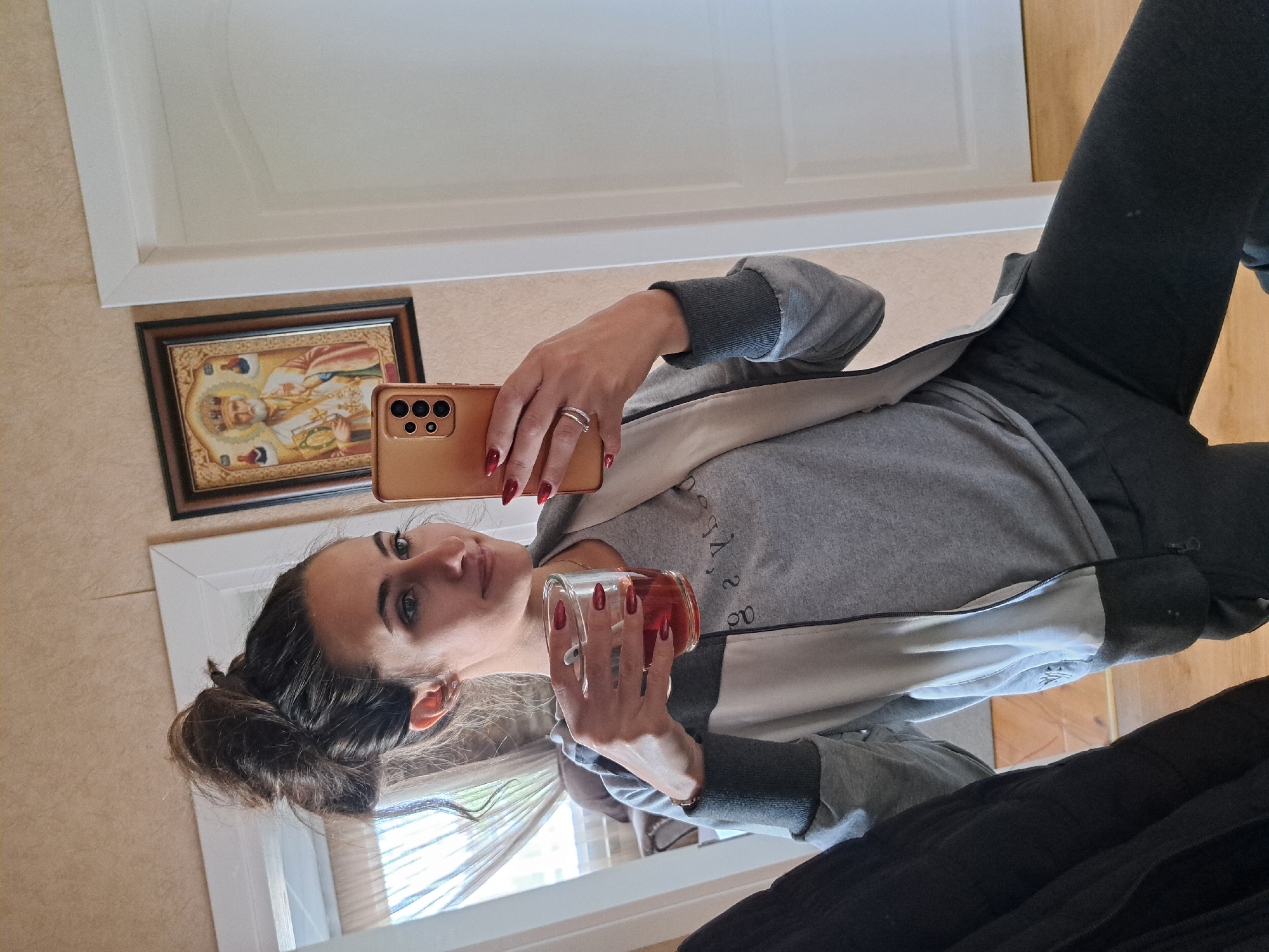 Woman takes playful selfies indoors in Bulgarian village