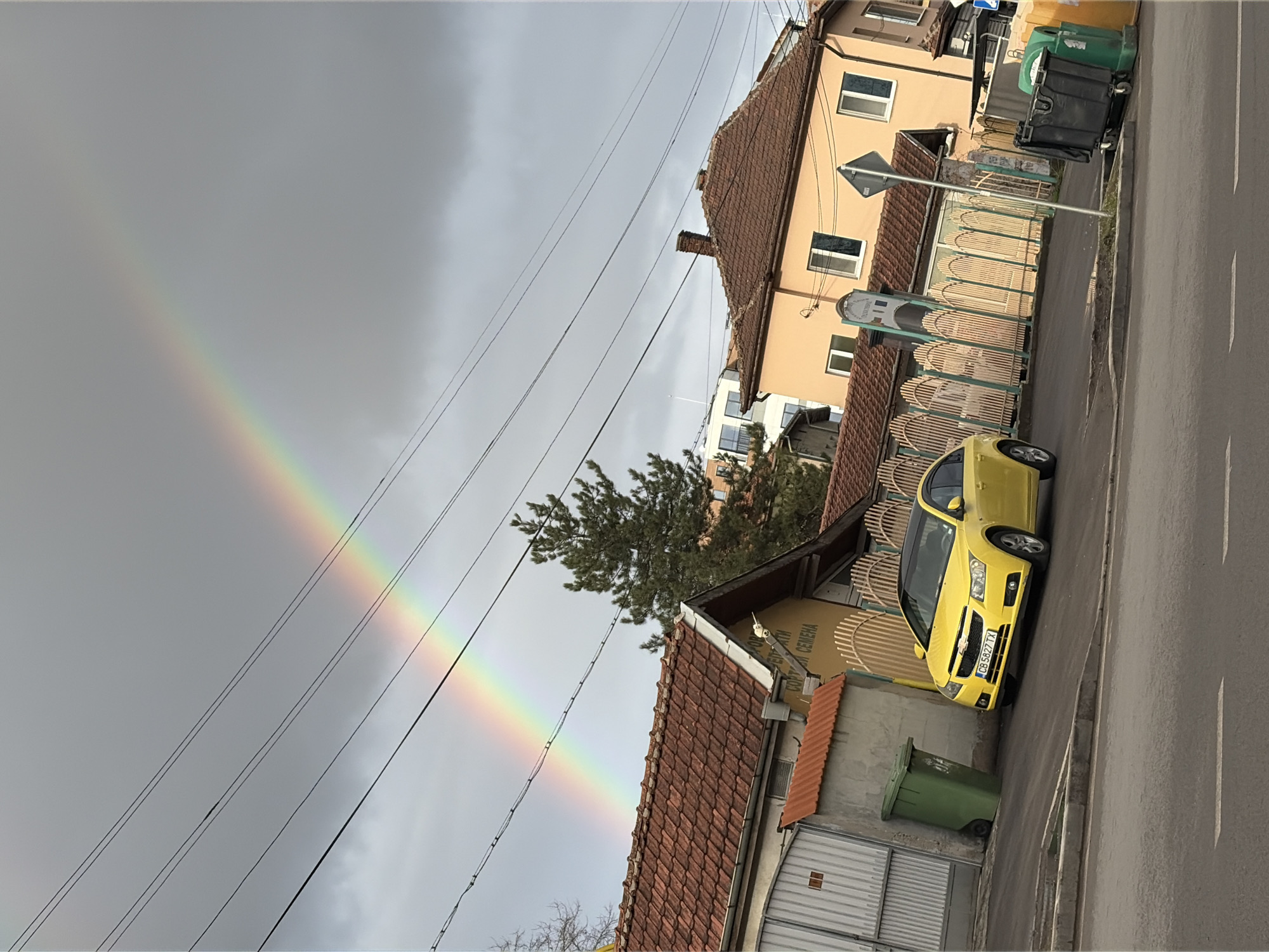 Rainbow appears over residential street in Kostinbrod, Bulgaria