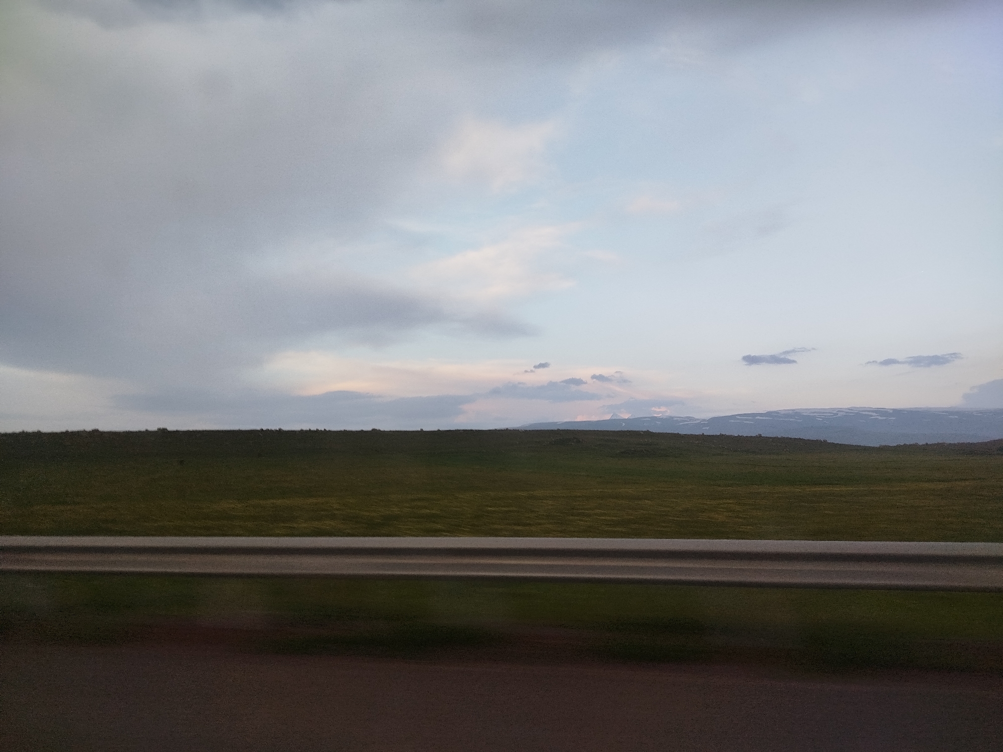 Overcast skies with colorful clouds observed over Armenian grasslands