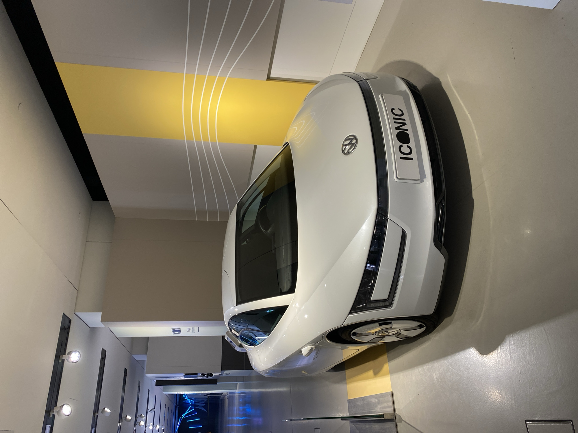 White 'ICONIC' car displayed indoors in Berlin facility