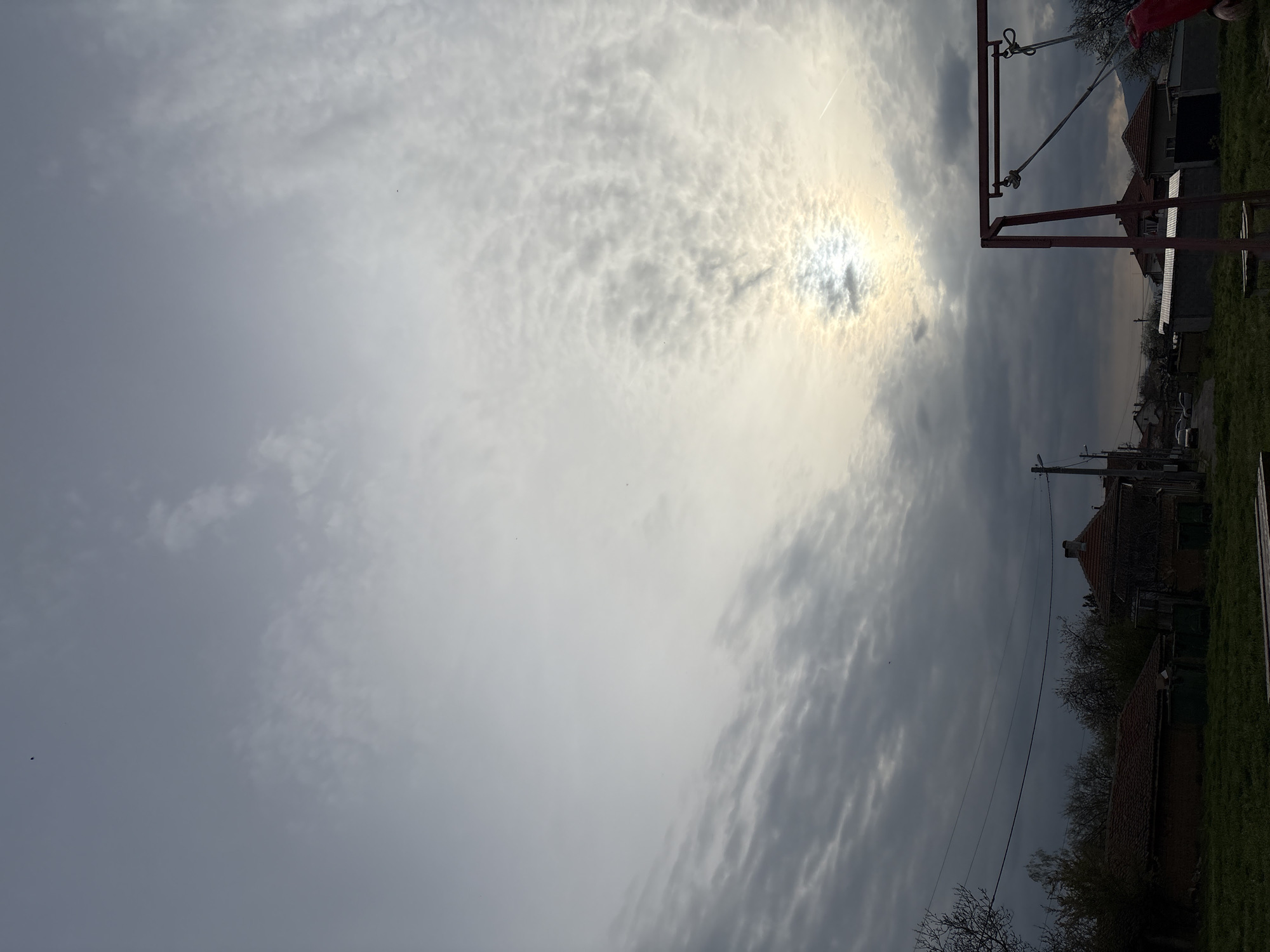 Playground and rural landscape observed under cloudy afternoon skies