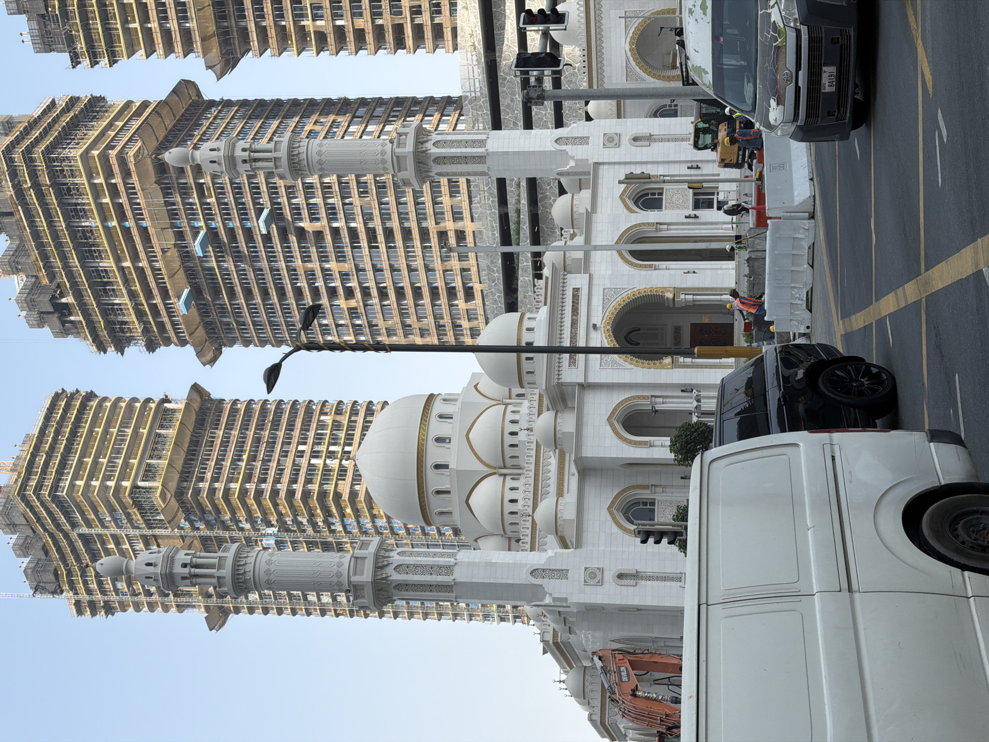 White mosque stands amid Dubai's ongoing high-rise construction