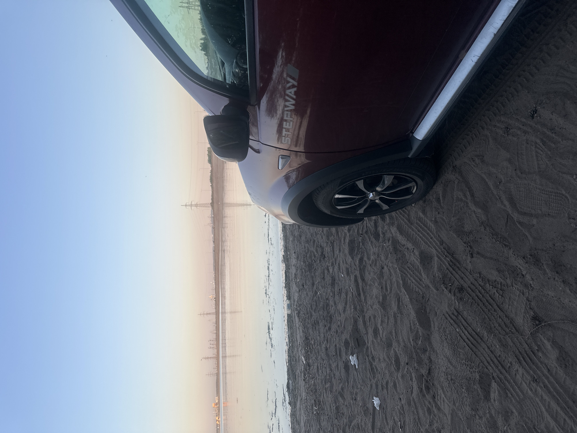 Maroon Dacia parked near water in Noviy, Russia