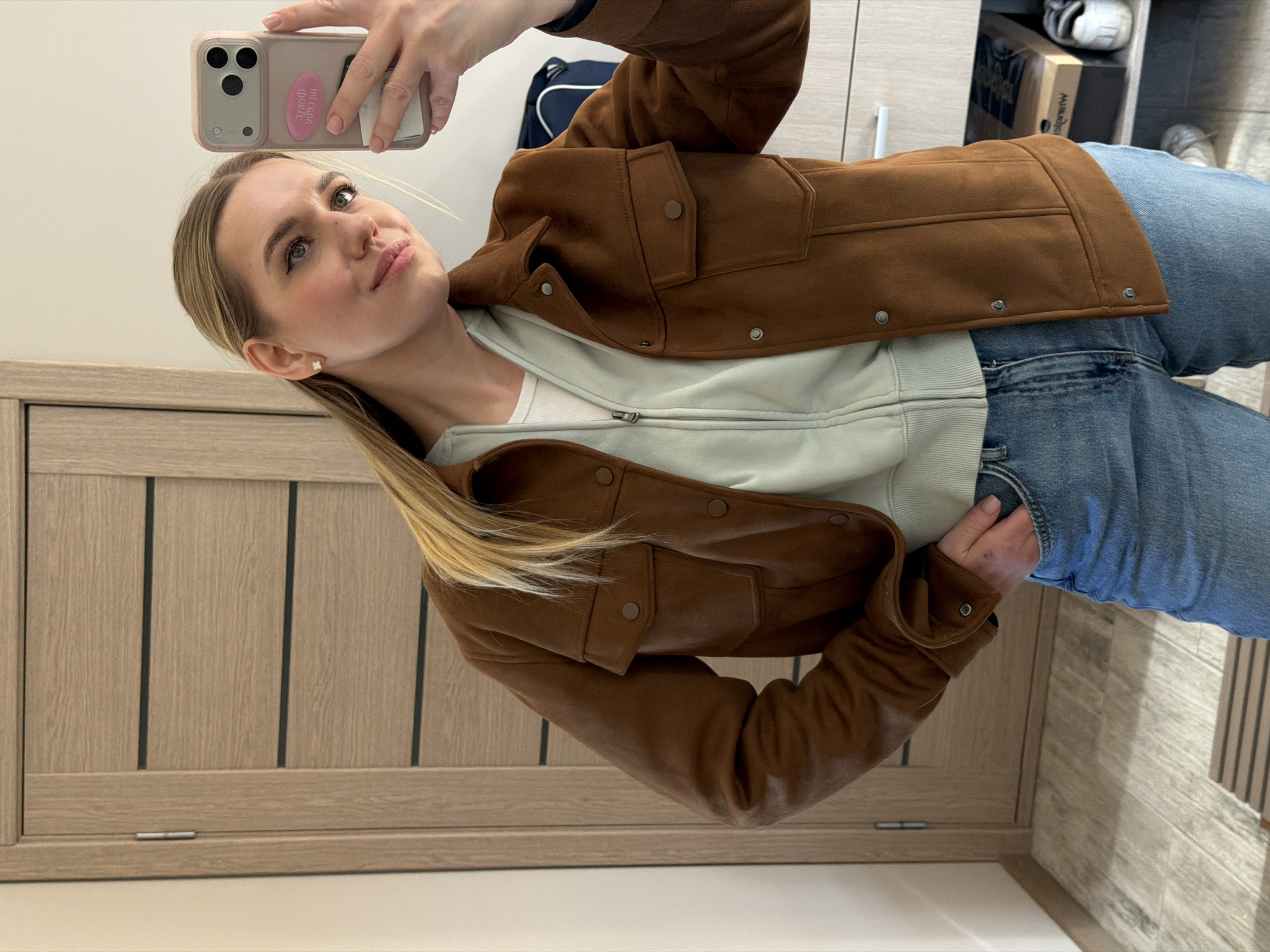 Woman takes mirror selfie in Dreiliņi, Latvia