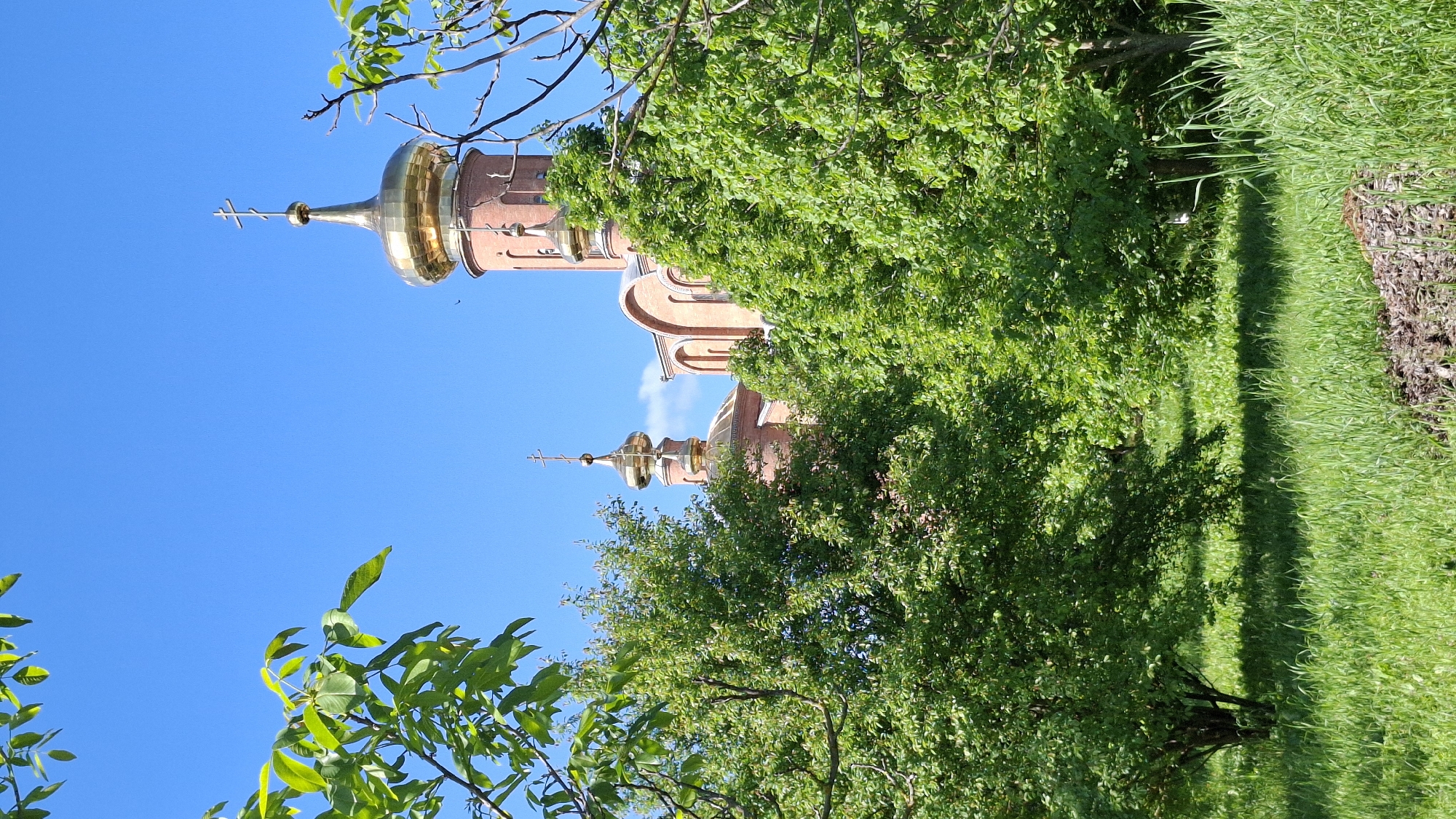 Religious building with golden domes observed during morning hours