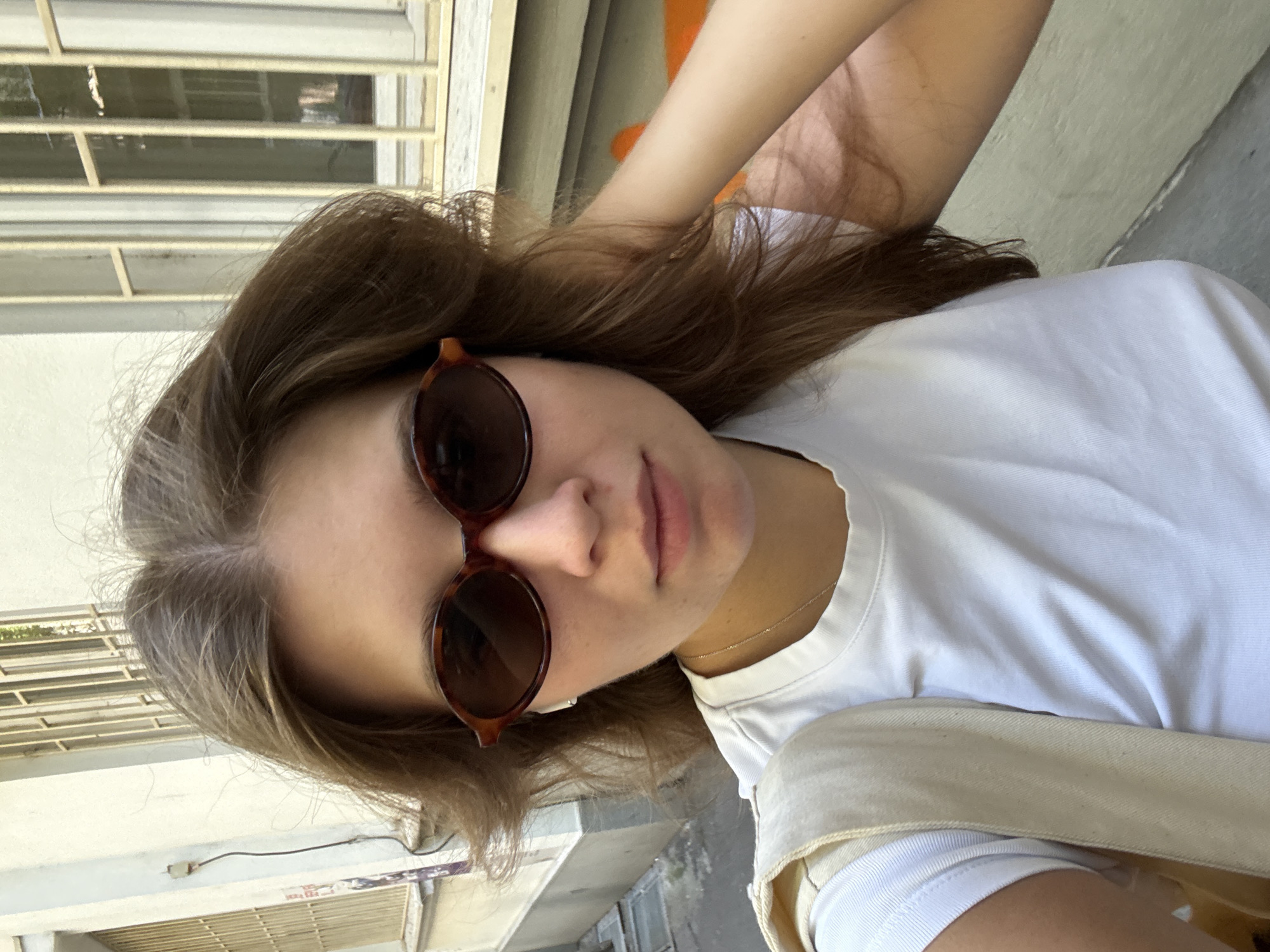 Woman takes selfie in graffitied Belgrade alleyway
