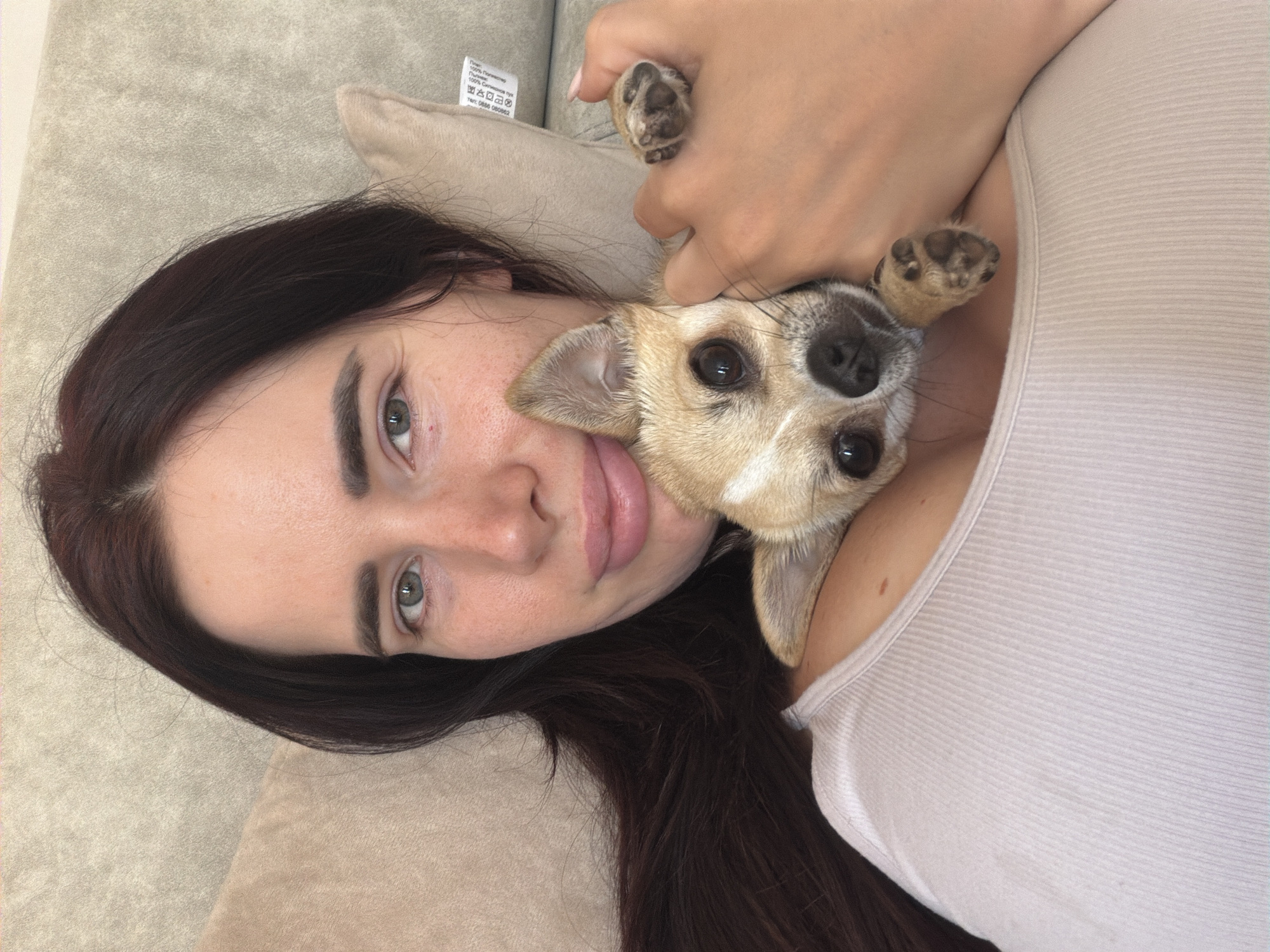 Woman and small dog share quiet afternoon moments in Sofia home