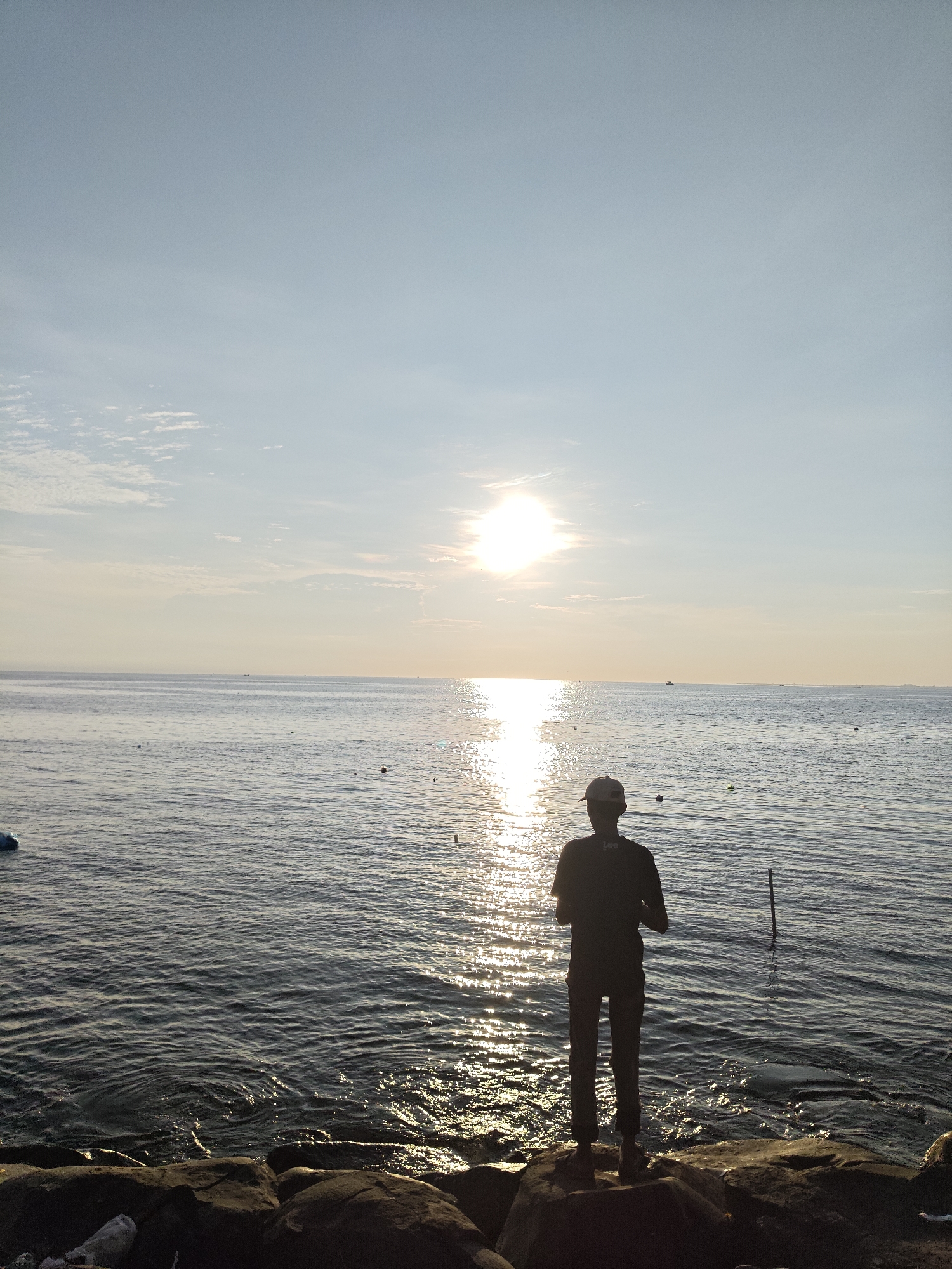 Sunset fishing scene captured along Lhokseumawe coastline