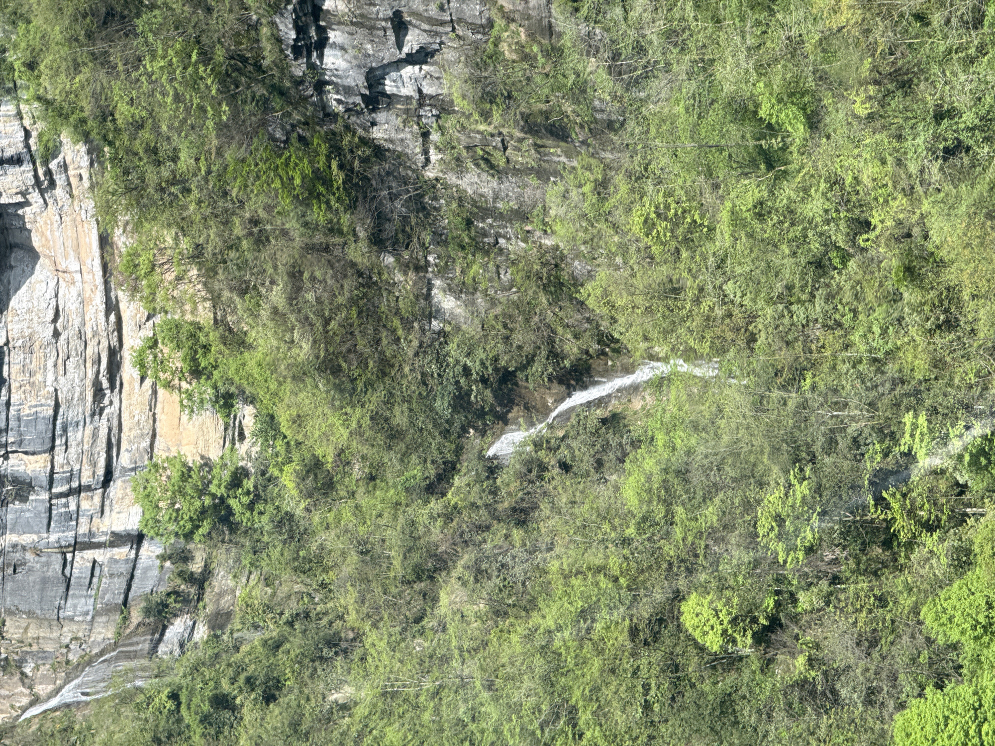 Cable car passenger photographs mountain scenery in Yongding District