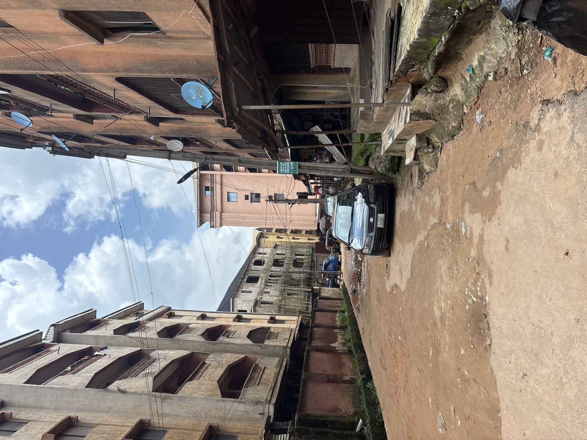Everyday street life along a potholed Onitsha neighborhood.