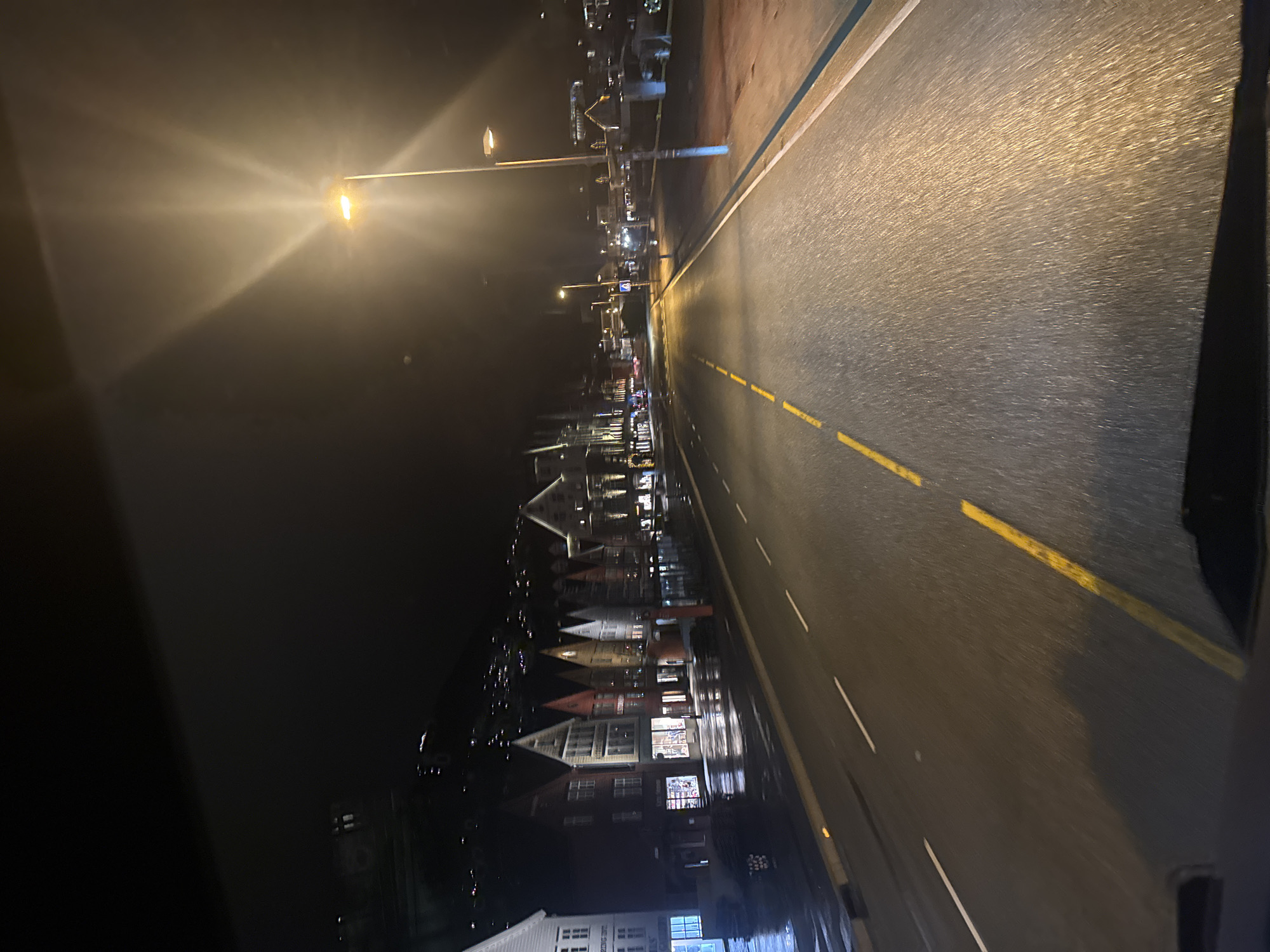 Nighttime street view captures illuminated Bergen waterfront district