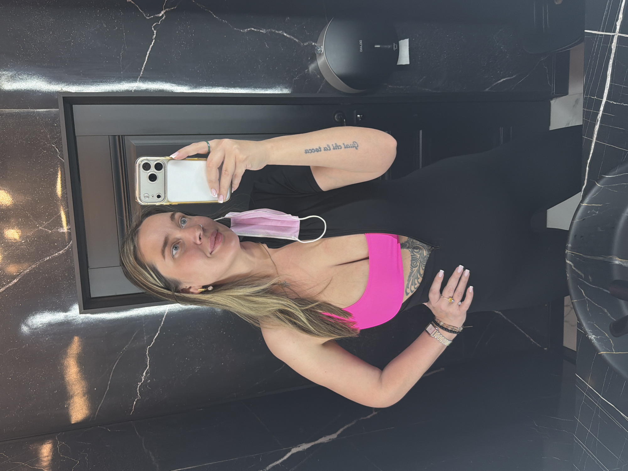Woman takes selfie in Moscow bathroom wearing athletic attire