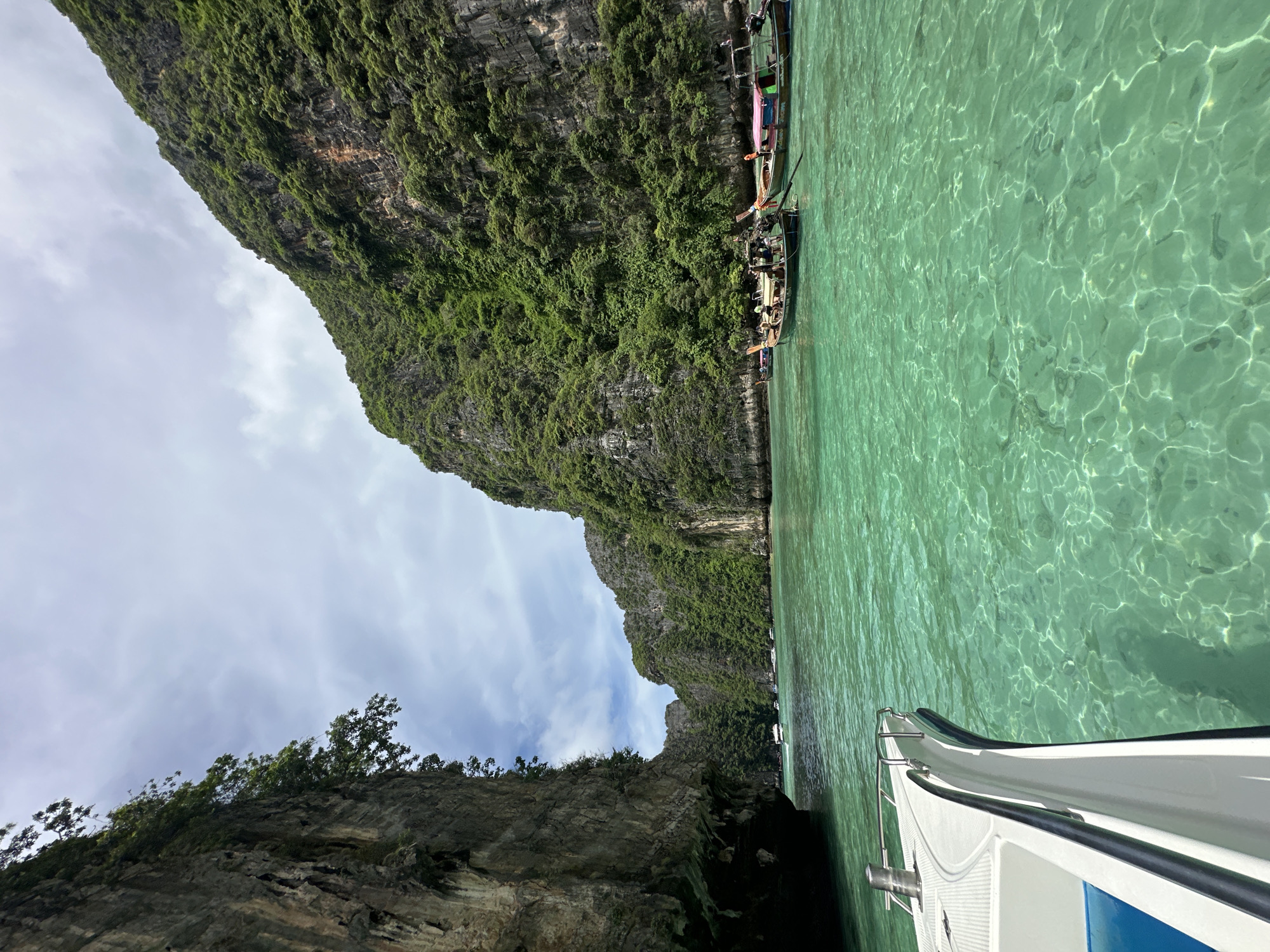 Longtail boats navigate turquoise bays among Krabi's limestone cliffs