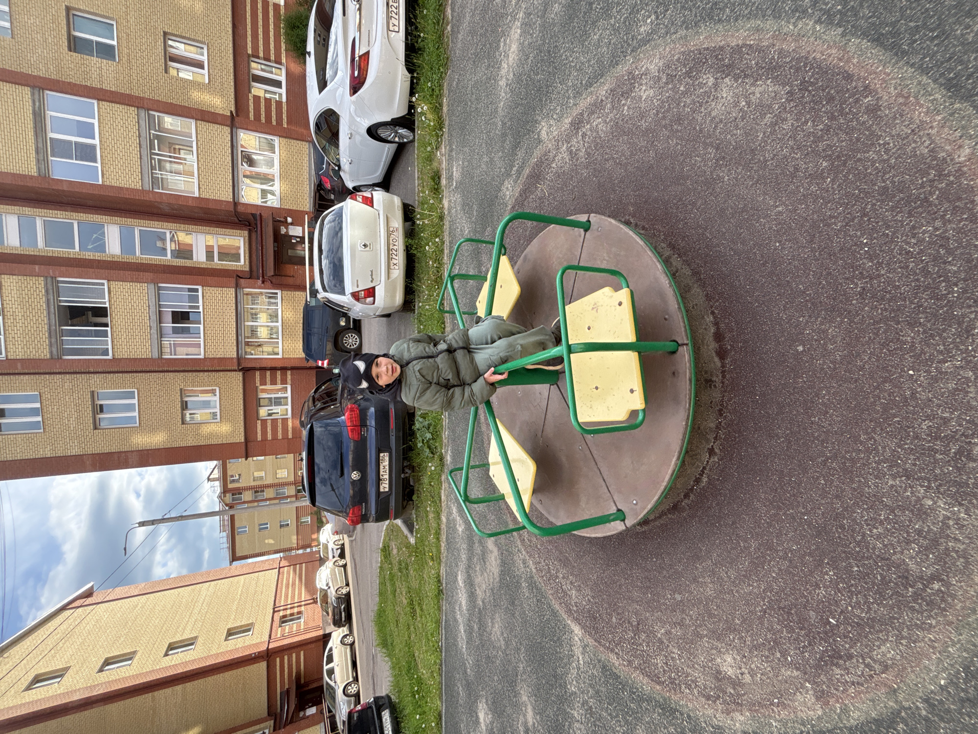 Child plays on carousel at Yaroslavl playground