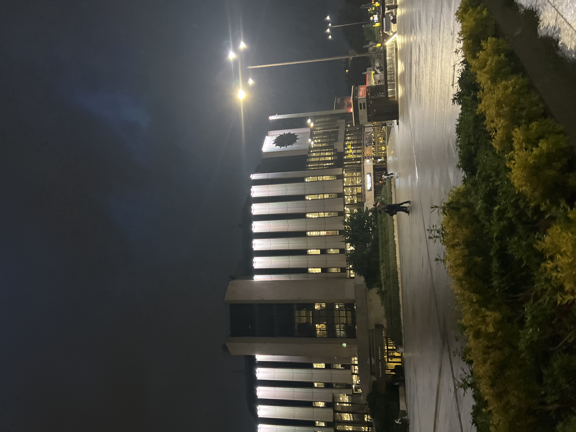 Modern building with clock documented in nighttime Sofia