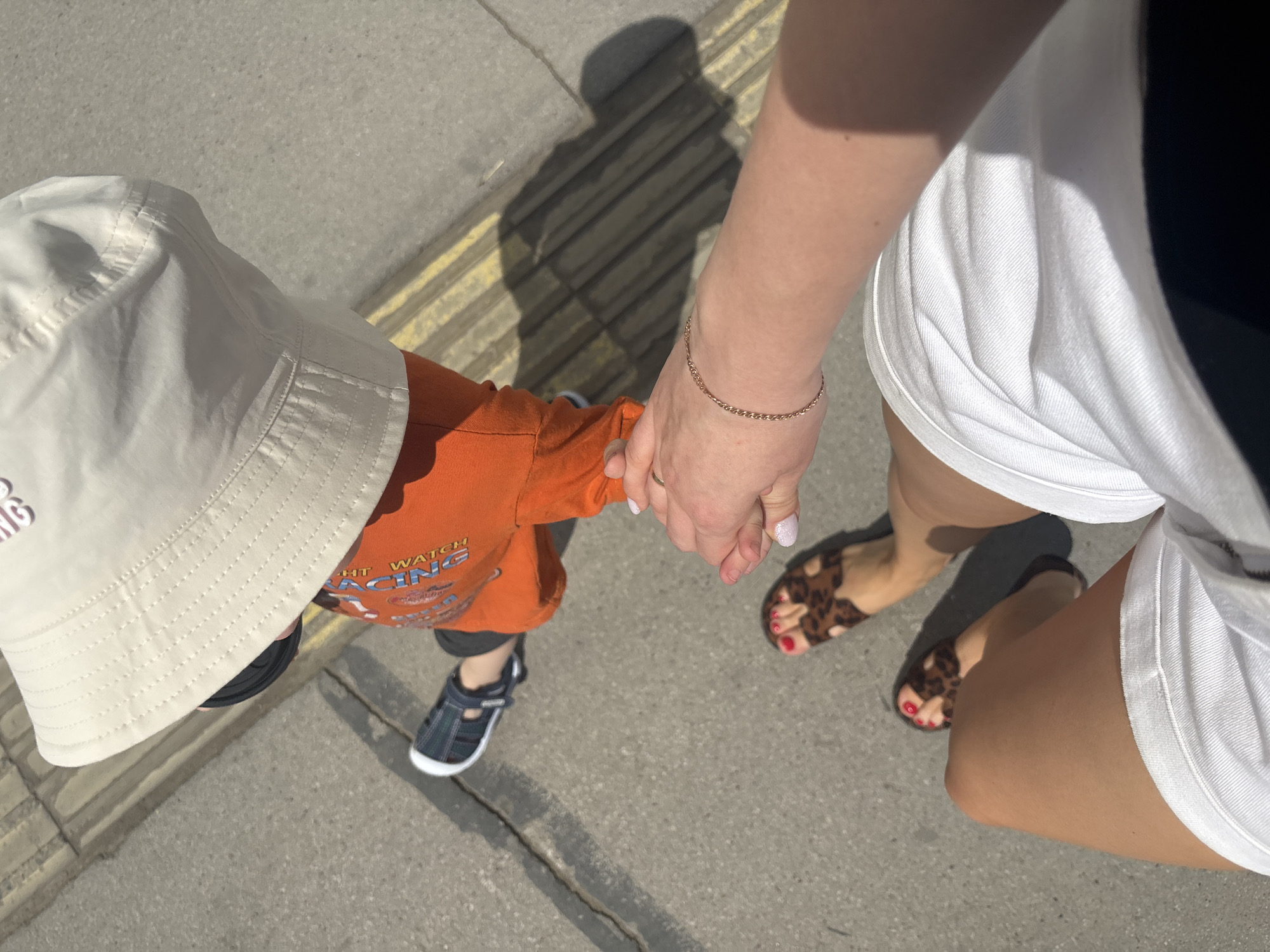 Parent and toddler spotted during casual sidewalk stroll in Perm