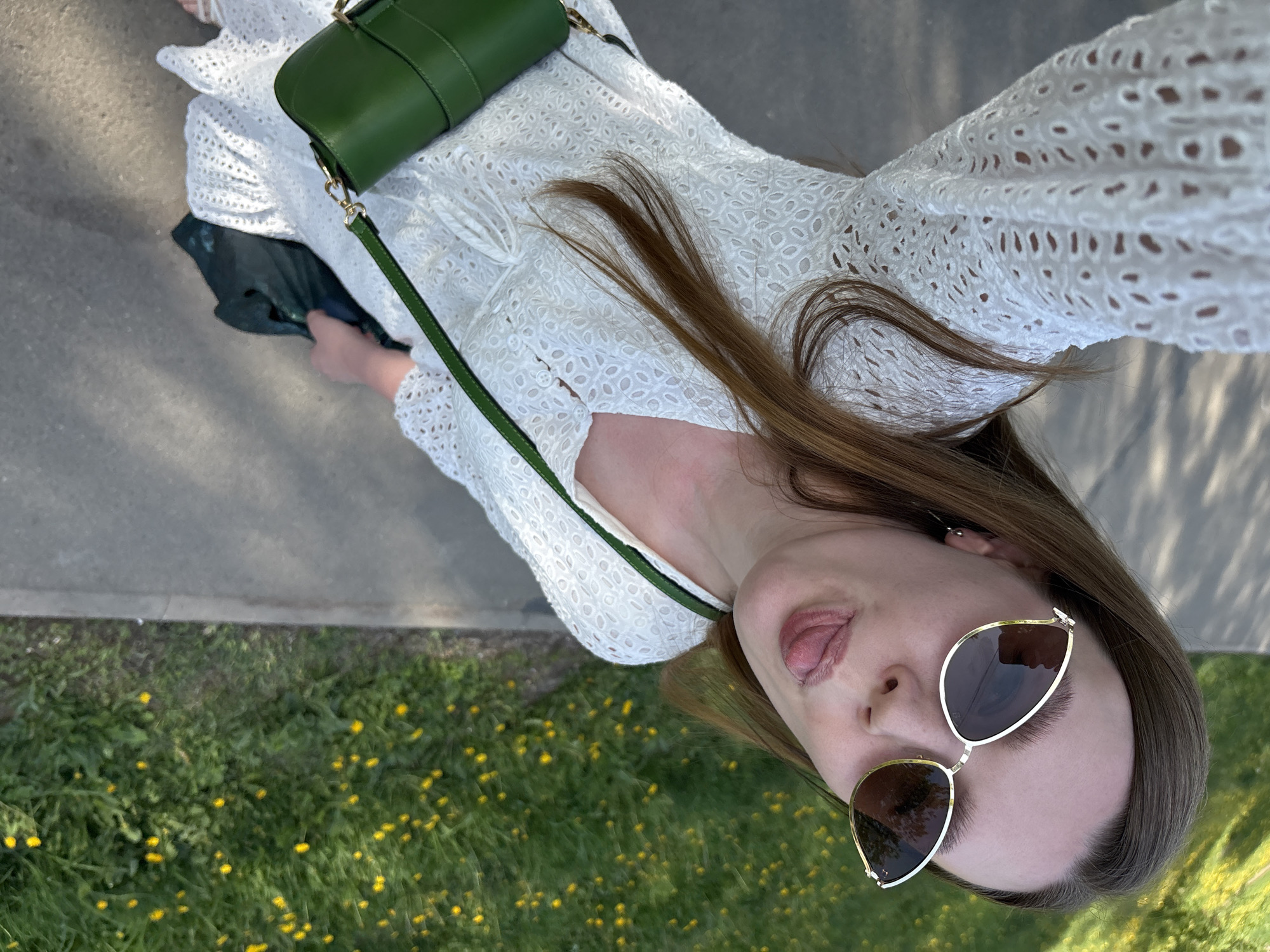 Woman poses playfully for photos on Izhevsk sidewalk