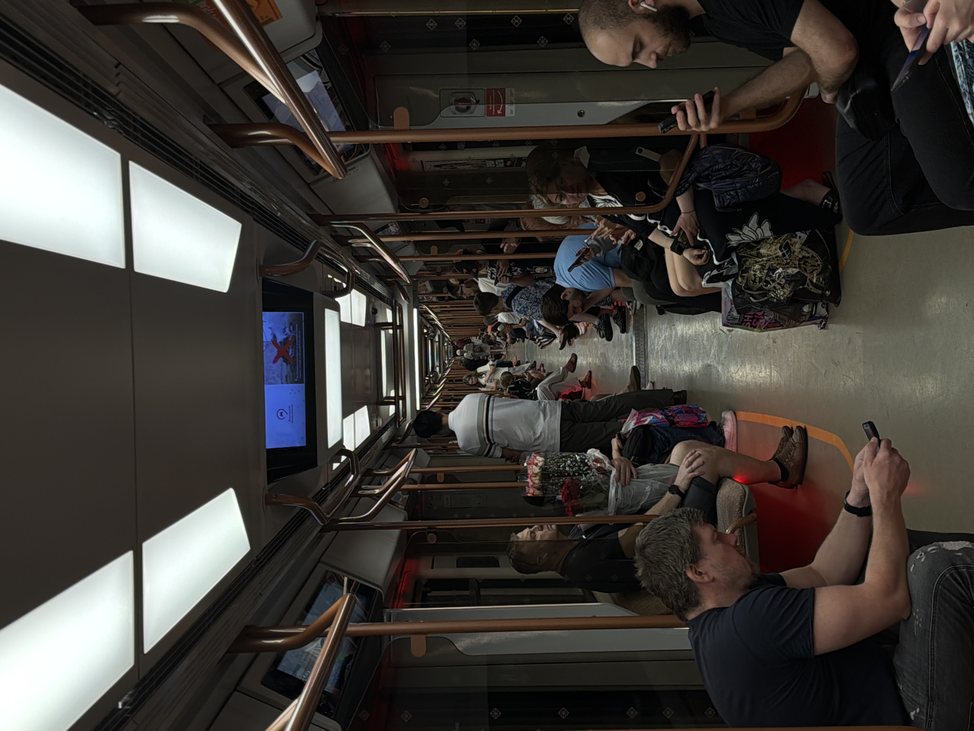 Crowded Moscow Metro car captures typical morning commute scene