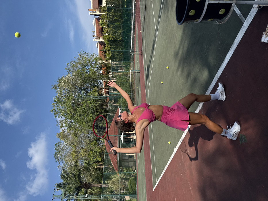 Woman plays early morning tennis in Choeng Thale, Thailand