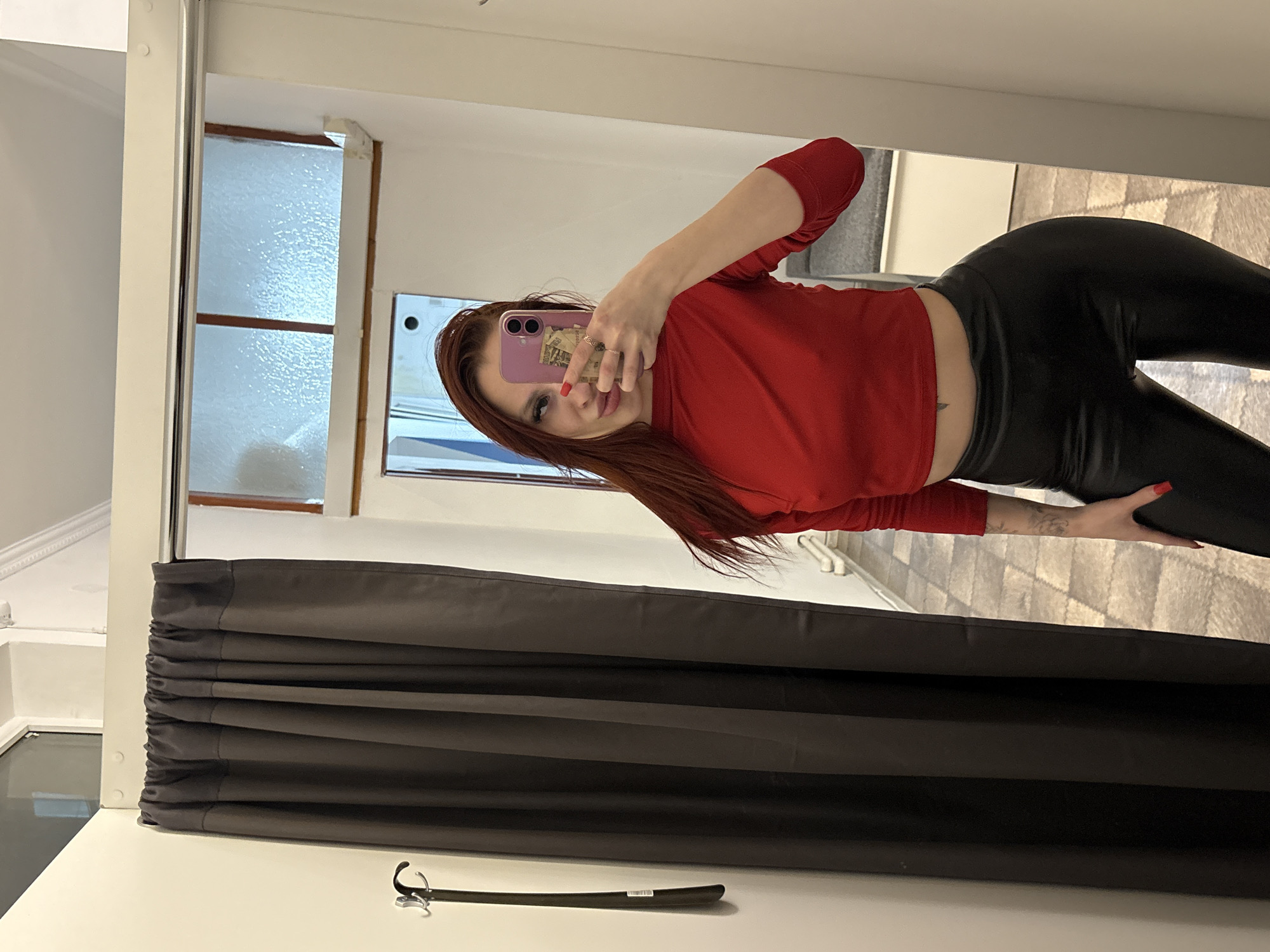 Woman takes selfies with cash-equipped phone in Simferopol dressing room