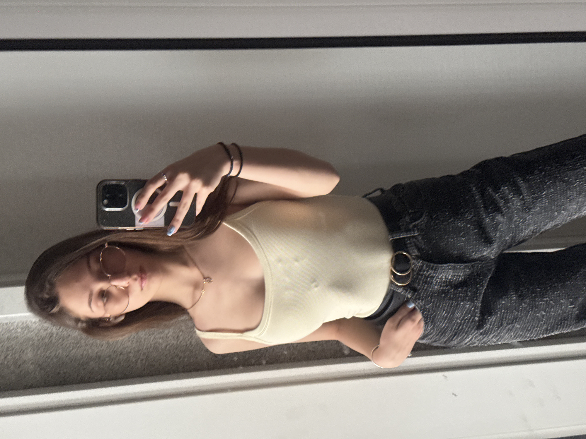 Woman takes mirror selfie in Sofia wearing trendy outfit