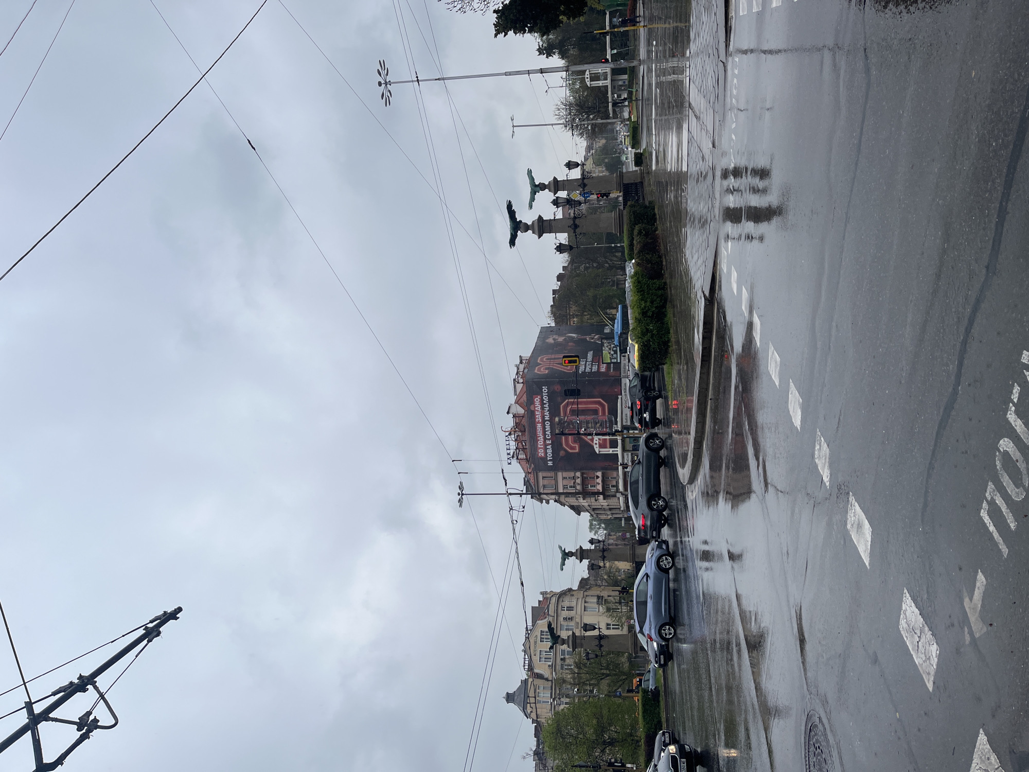 Rainy morning documented across Sofia streets, pedestrians use umbrellas