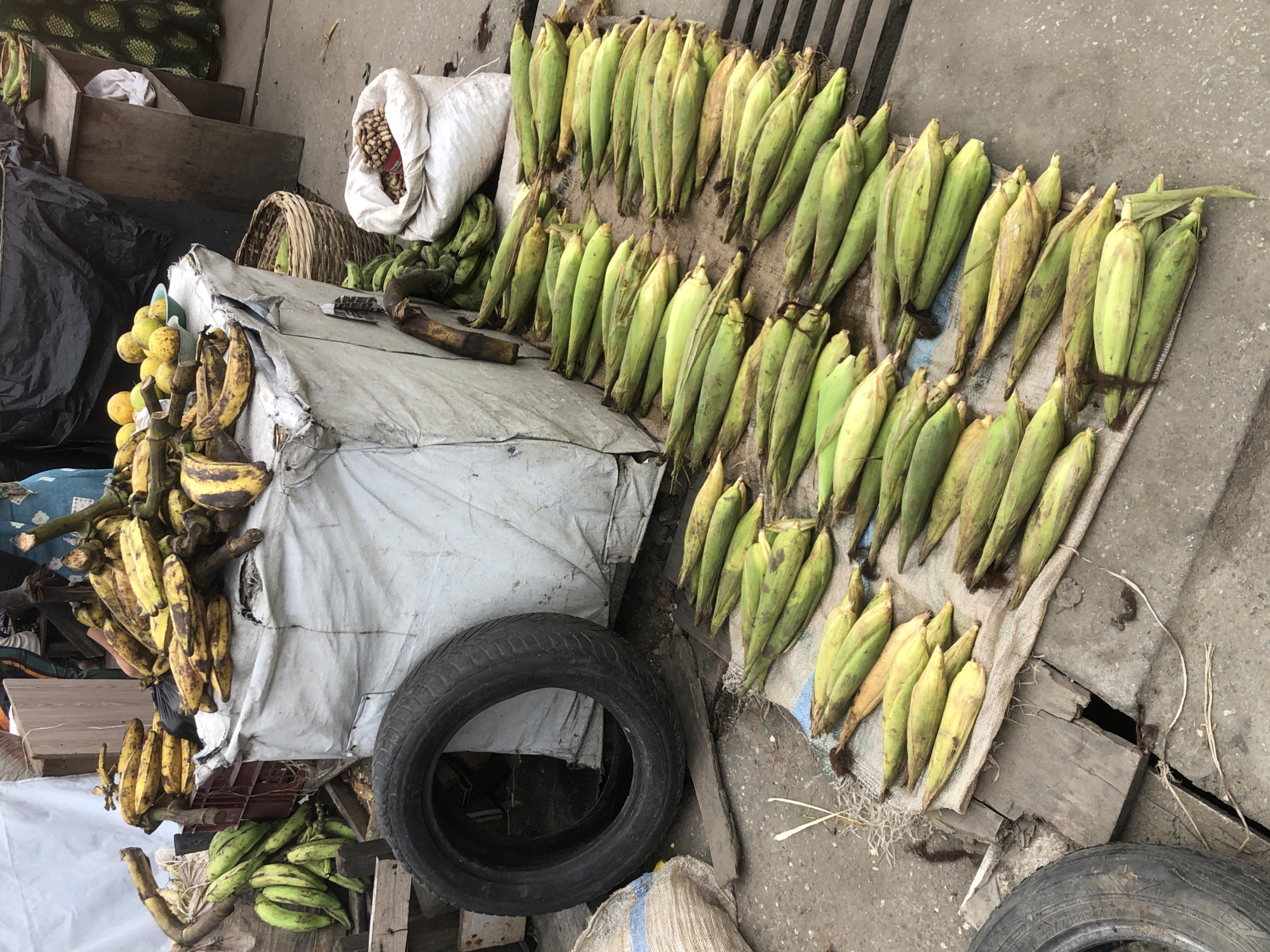 Fresh produce stalls and street vendors at a Lagos market