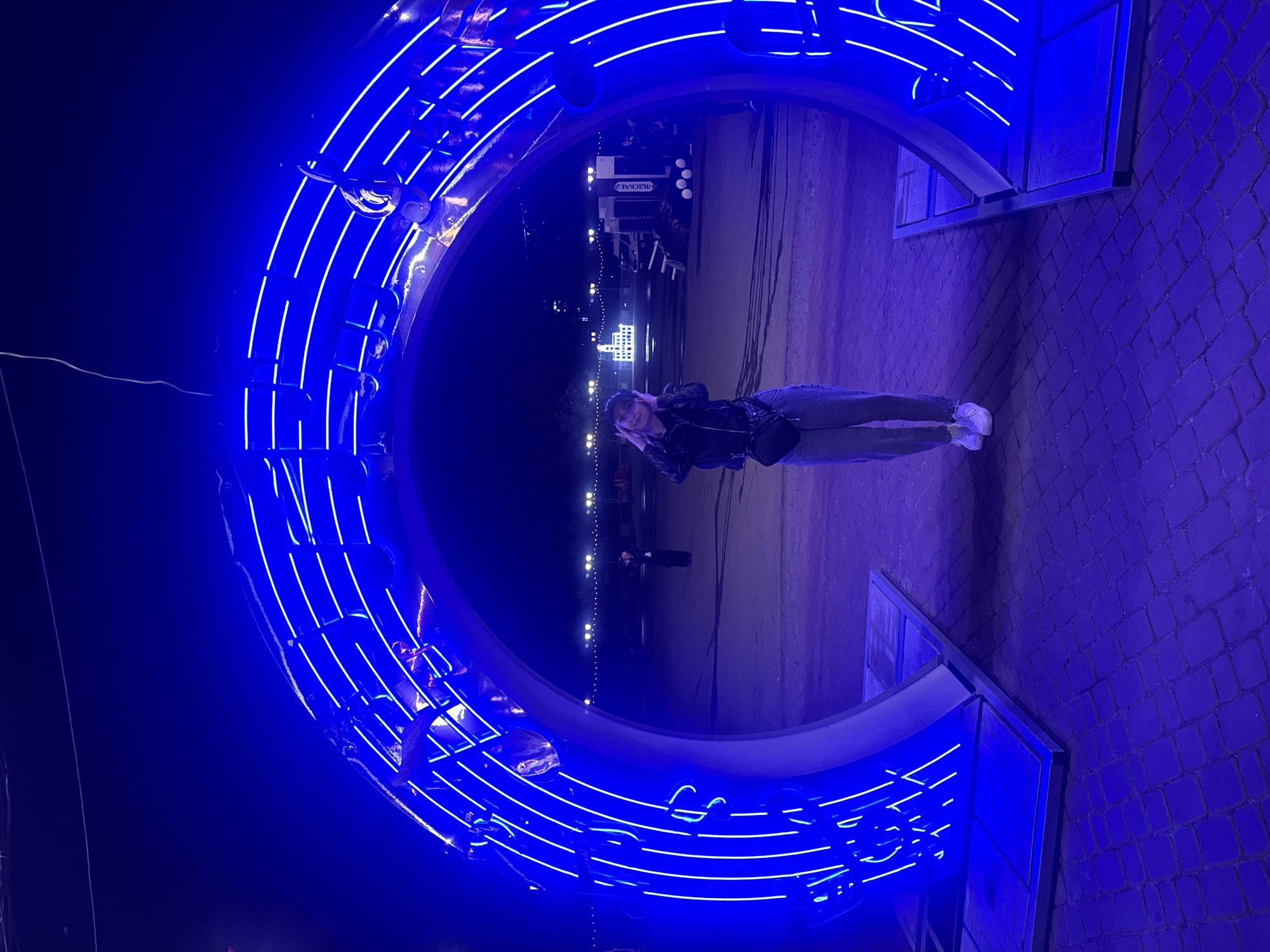 Blue neon music installation and Eastern European street at night